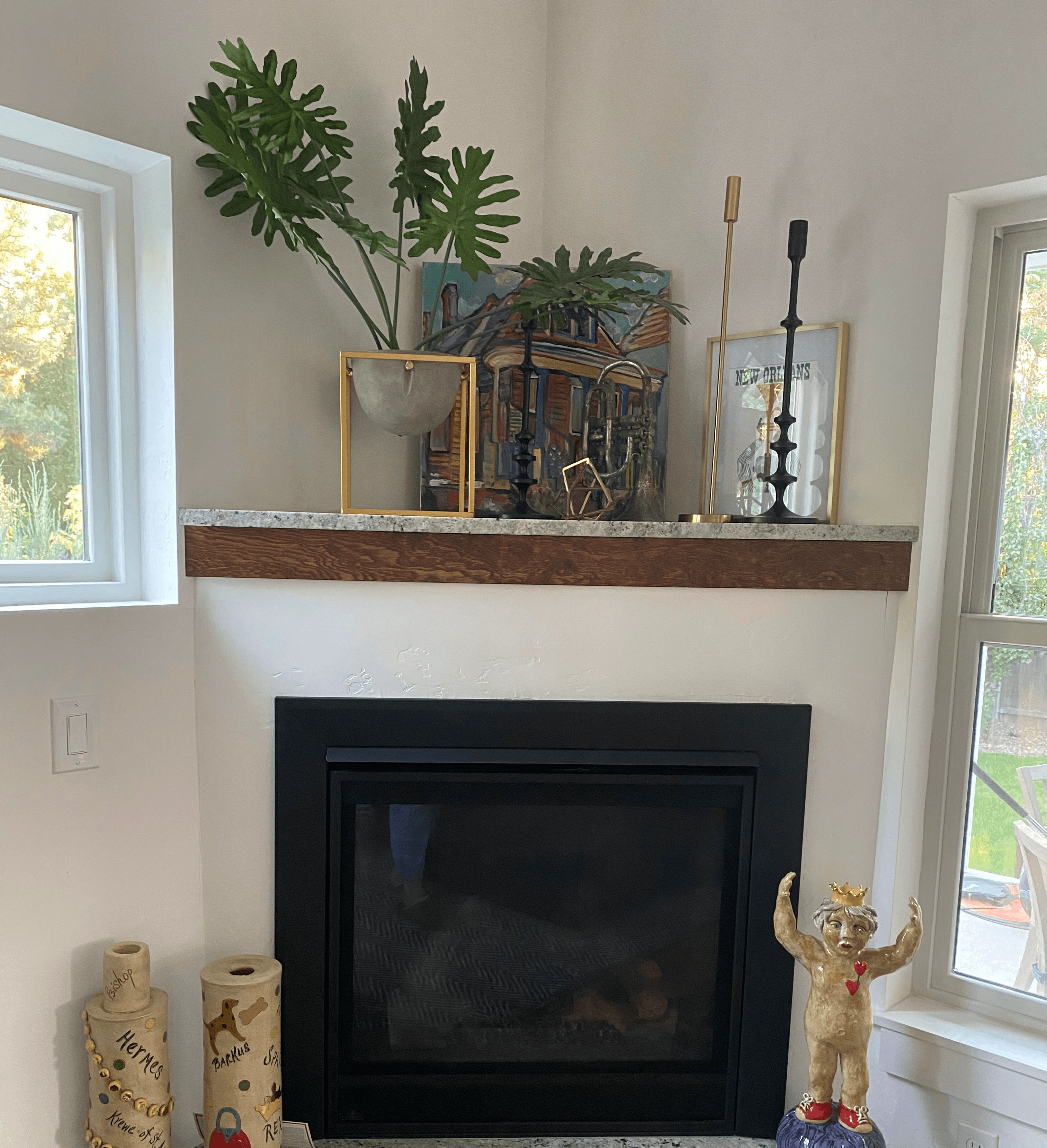 fireplace with home decor and plants and candlesticks