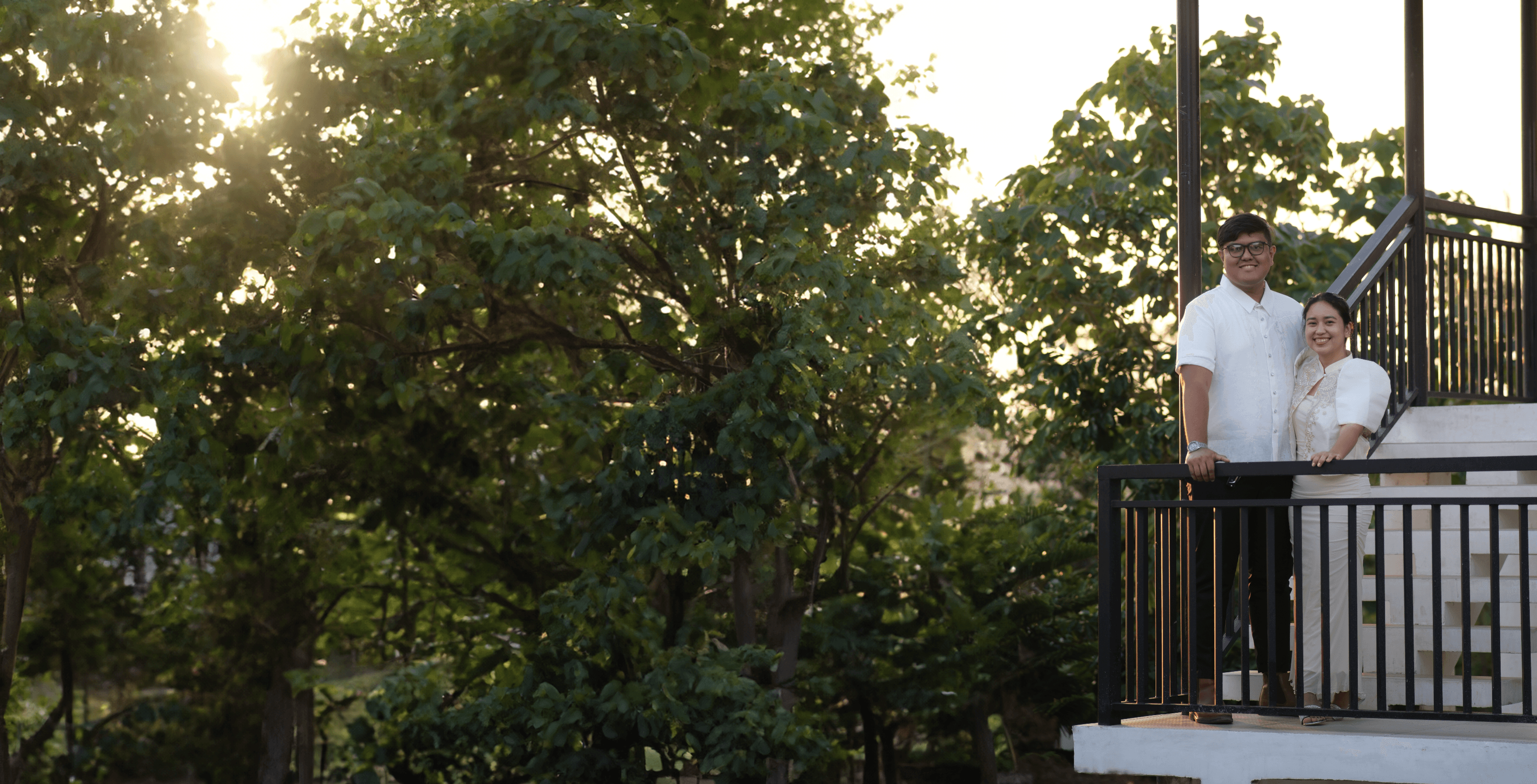 woman holding a phone and man looking at the phone. both are smiling