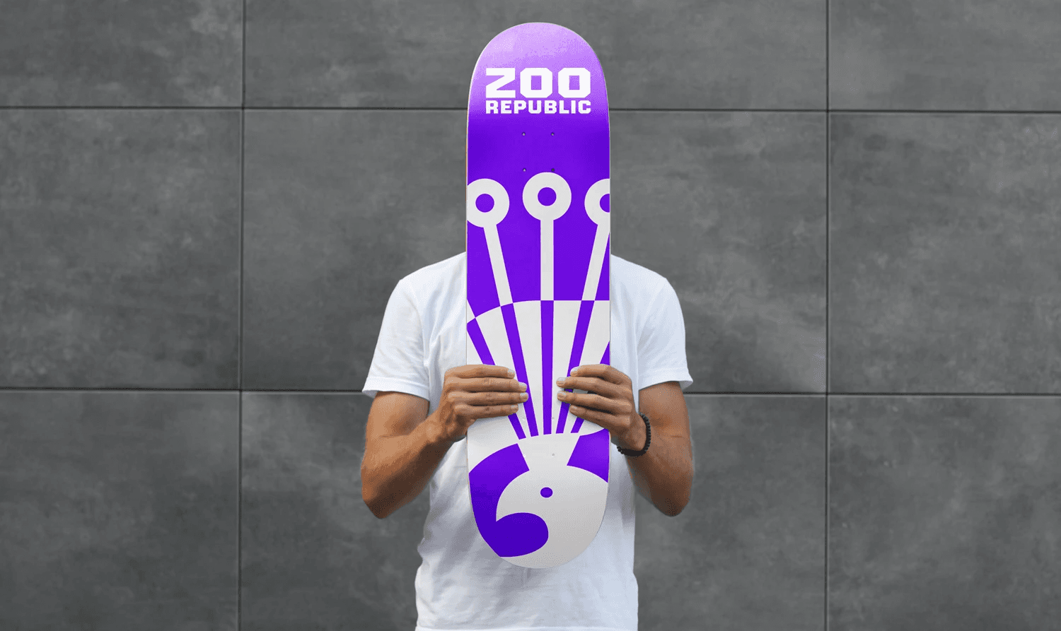 man holding a purple skateboard