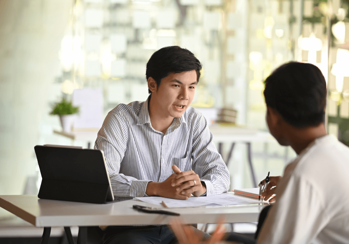 Close-up of a dark green leaf showing its textured surface and central vein against a muted background.