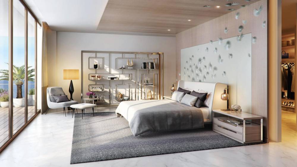 The Royal Atlantis bedroom showcases a spacious bed and a sleek television in a contemporary design.