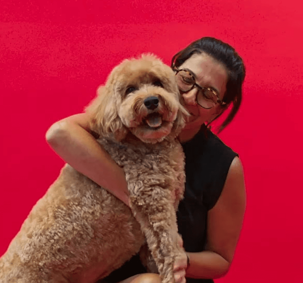 Candid photo of a man cuddling two small dogs to show affection, comfort, and personalized pet care.