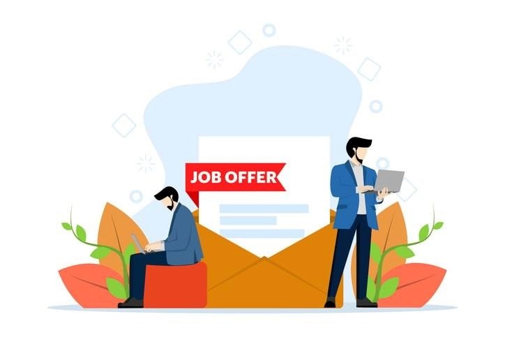 A person contemplating a job offer while sitting at a desk.
