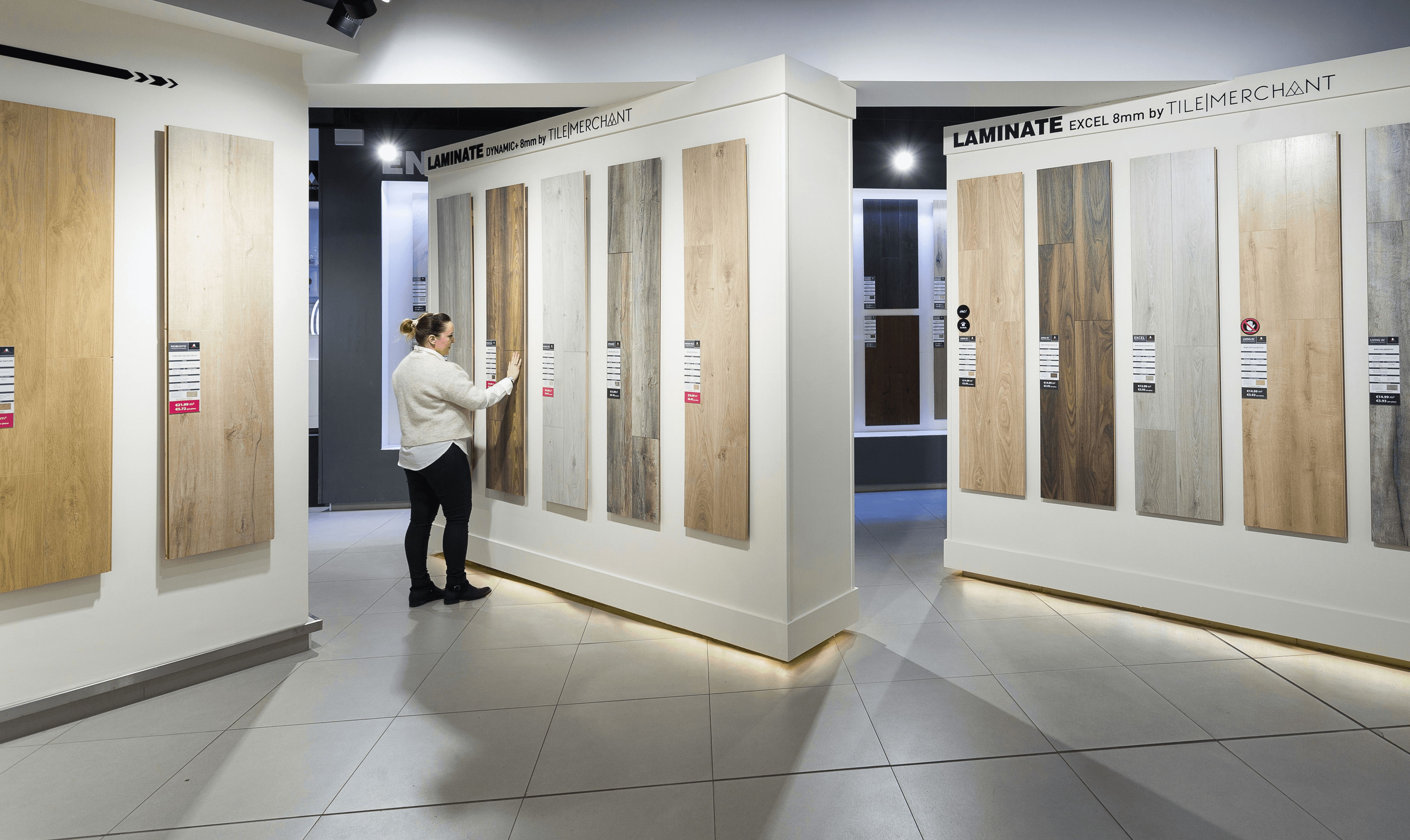 a man standing in front of a display of wooden doors