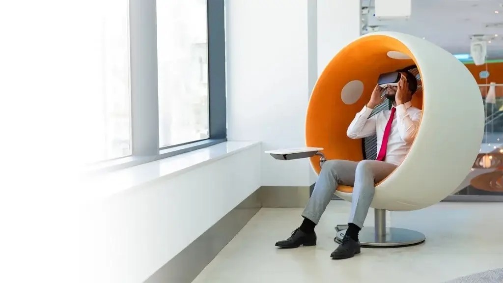 AR and VR Transforming Businesses Man office employee sitting on round chair using vr headset