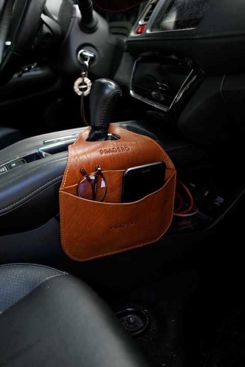 Close-up of a dark green leaf showing its textured surface and central vein against a muted background.