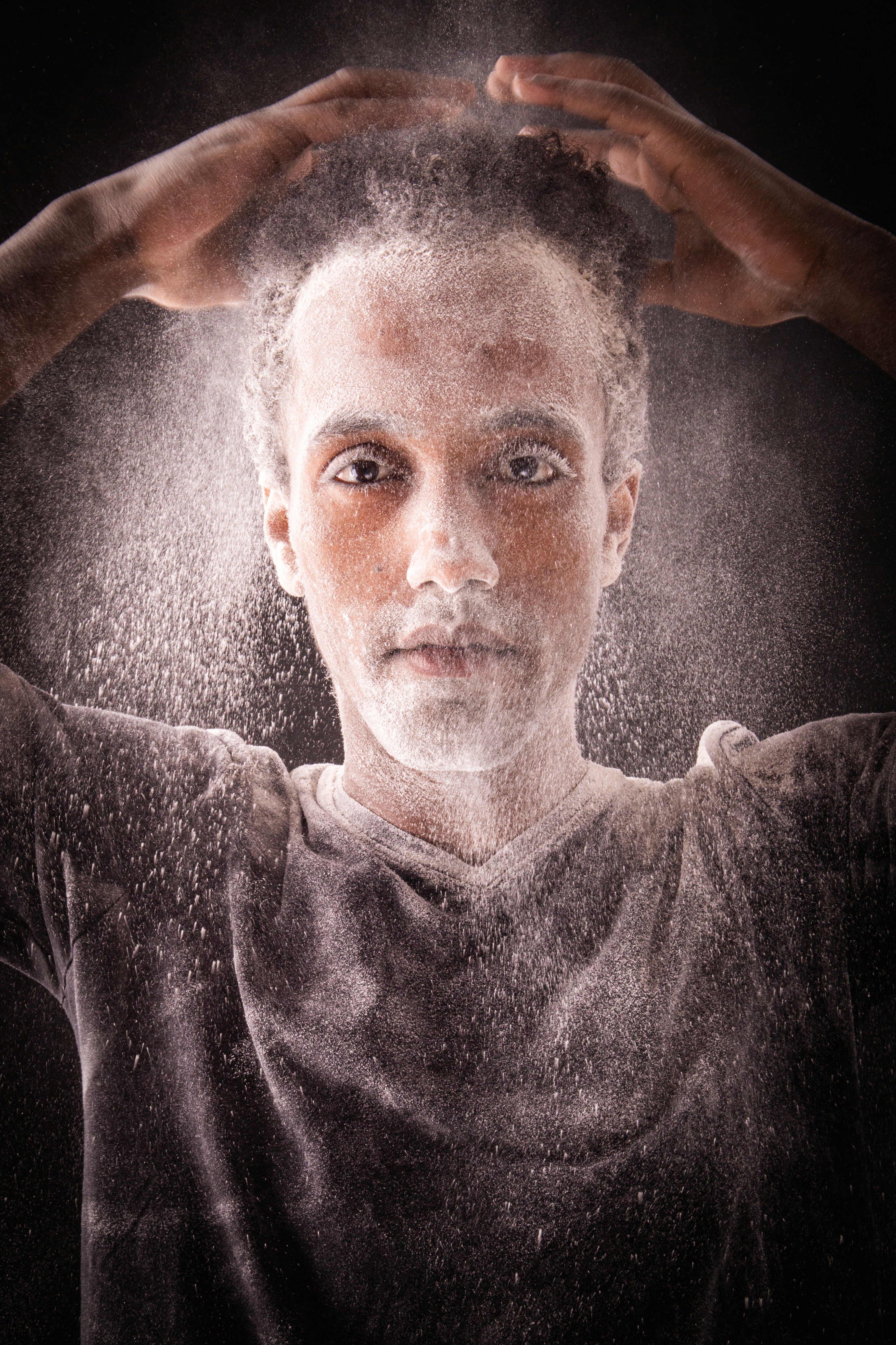 a woman sitting on a chair with a hair dryer