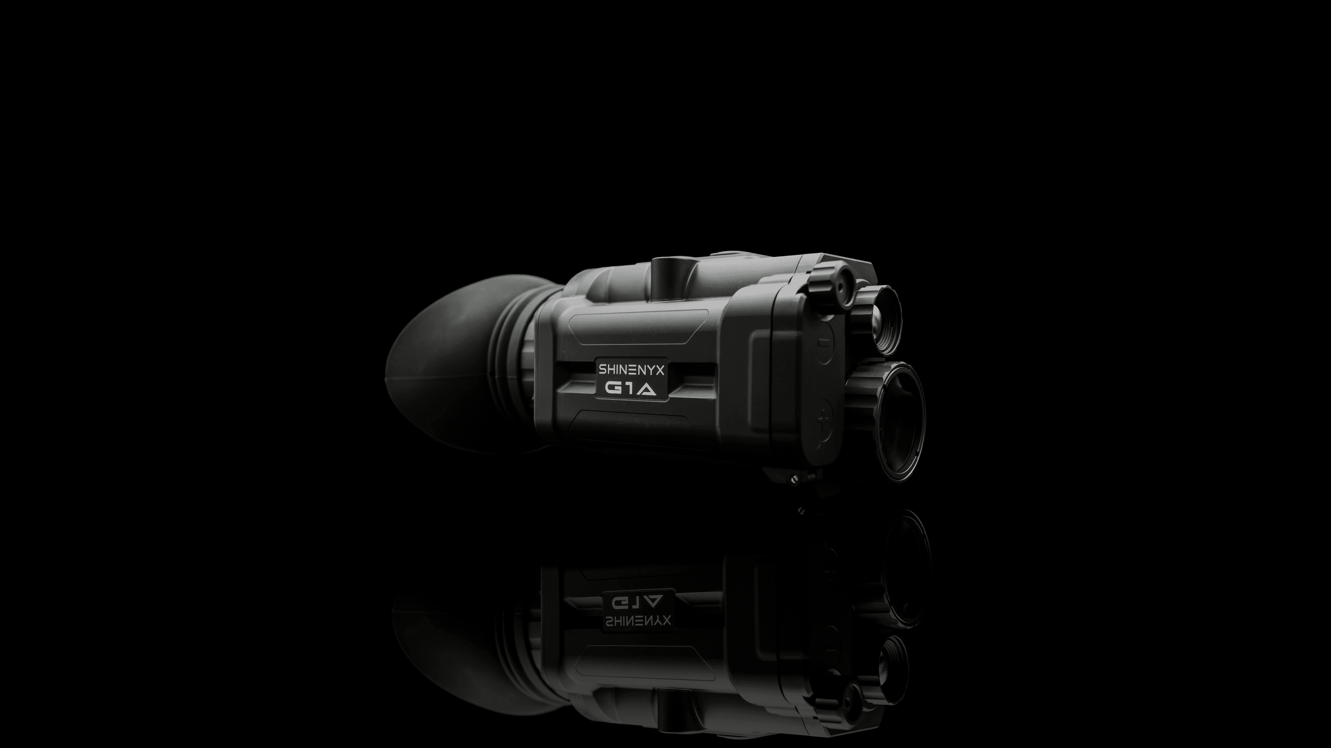 Close-up of a sleek silver sports car front with alloy wheel under dramatic studio lighting.