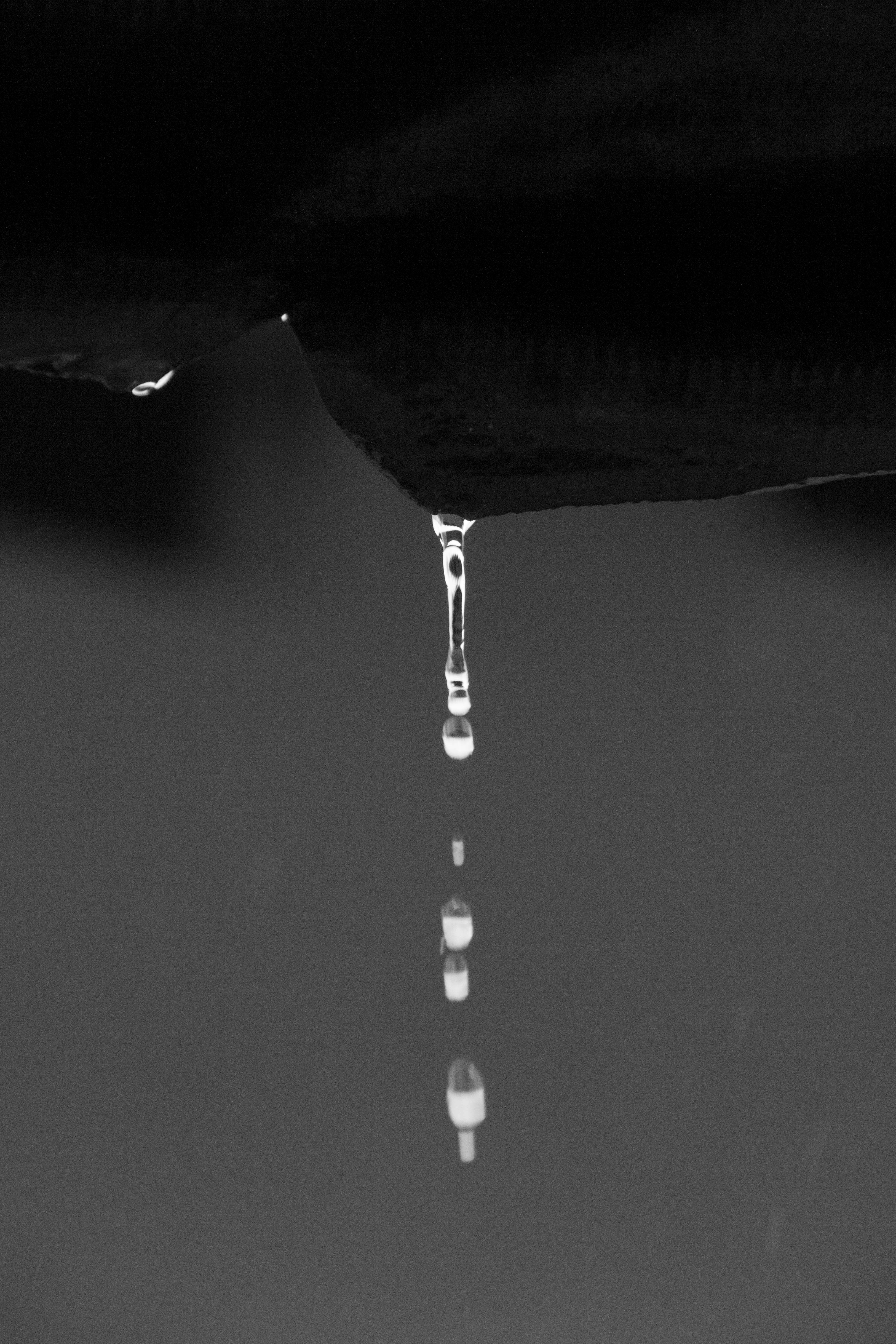 a black and white photo of a water drop
