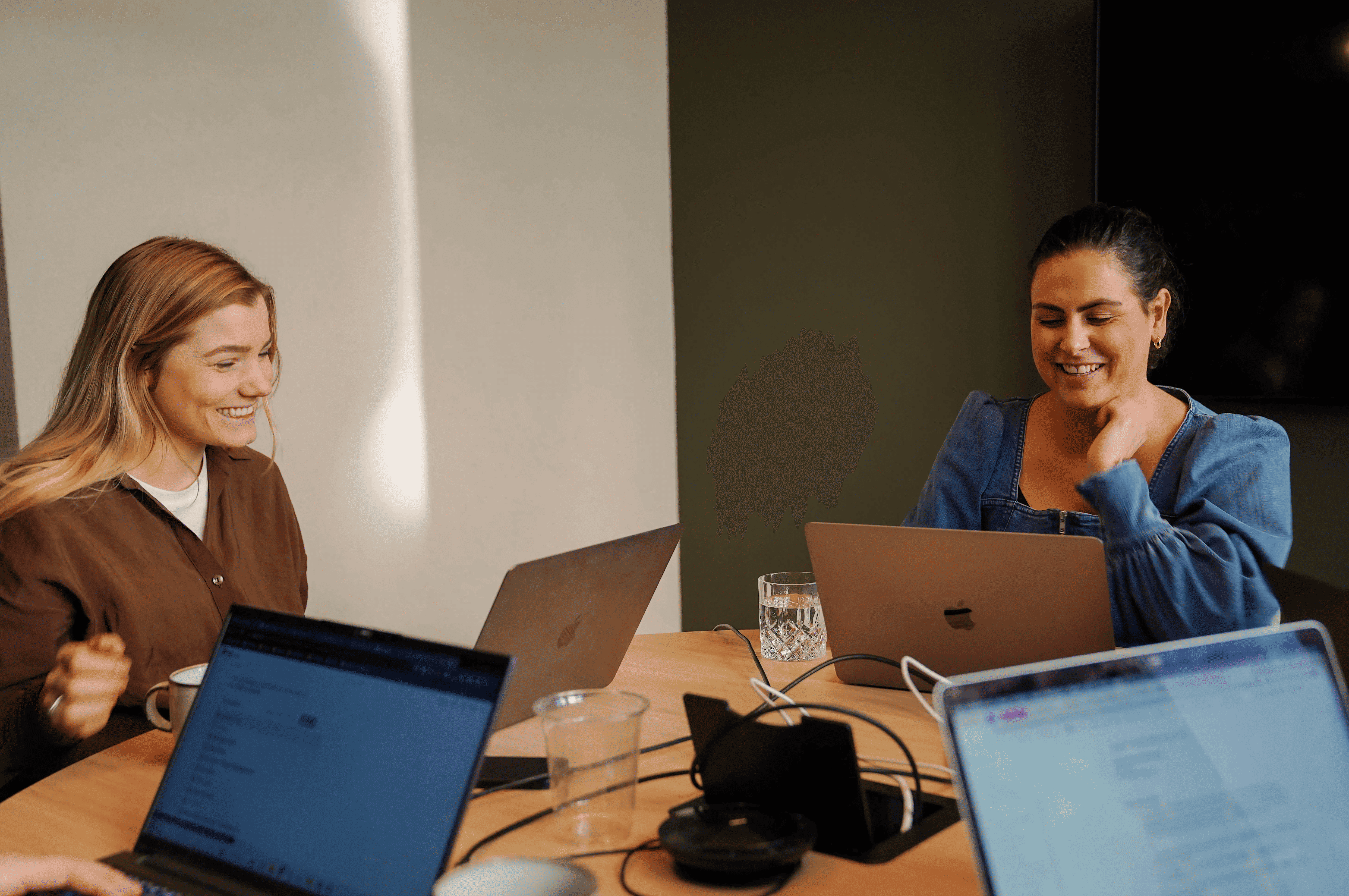 Two women having discussion in meeting room for recruiters highlighting collaboration