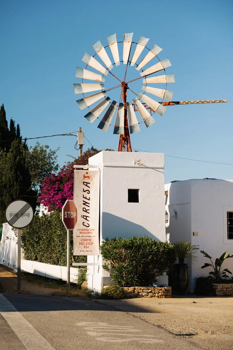 Exterior of Carnesa Churrascaria Brasiliana with windmill, a stylish Ibiza dining experience.