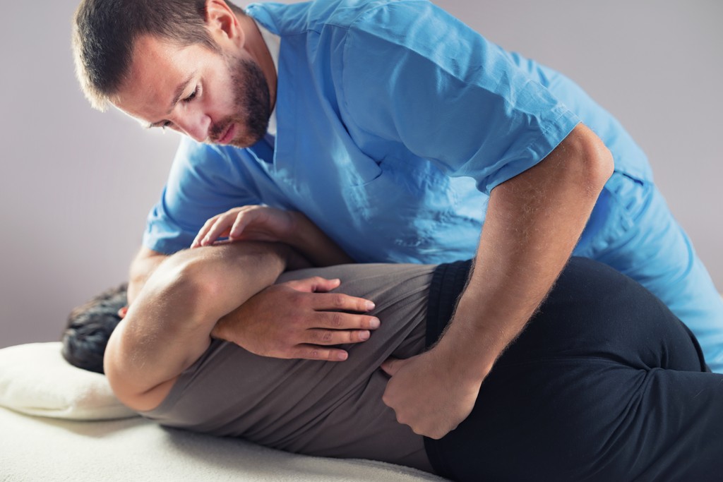 doctor adjusting a patients lower spine