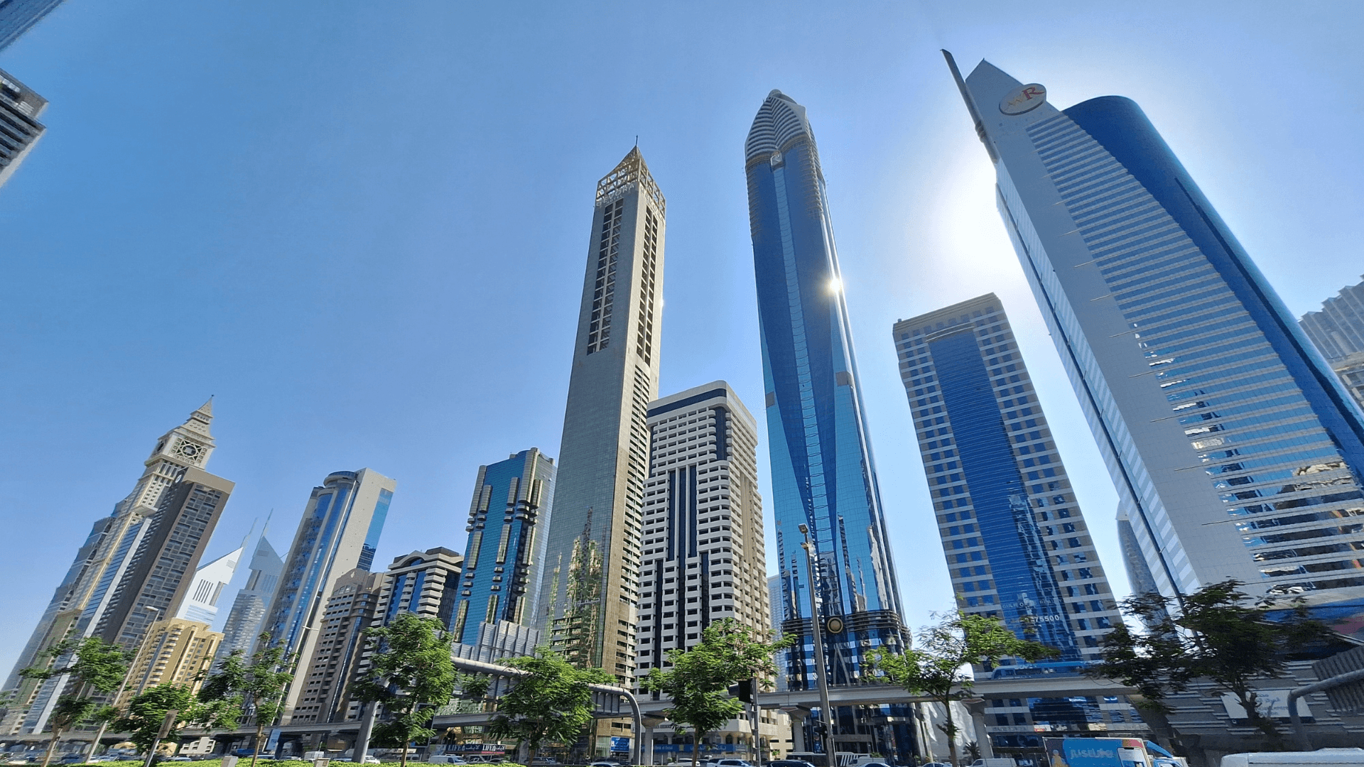 Cluster of luxury skyscrapers and hotel towers reflecting sunlight in a vibrant business district | Lunasole Hospitality