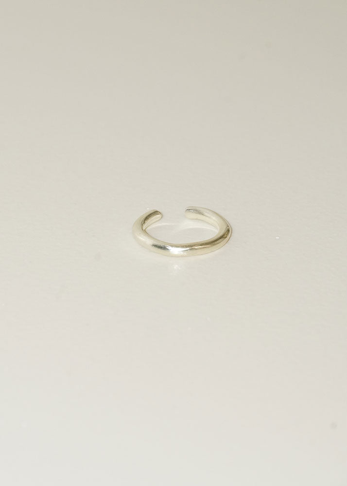 Silver ring on a light beige background