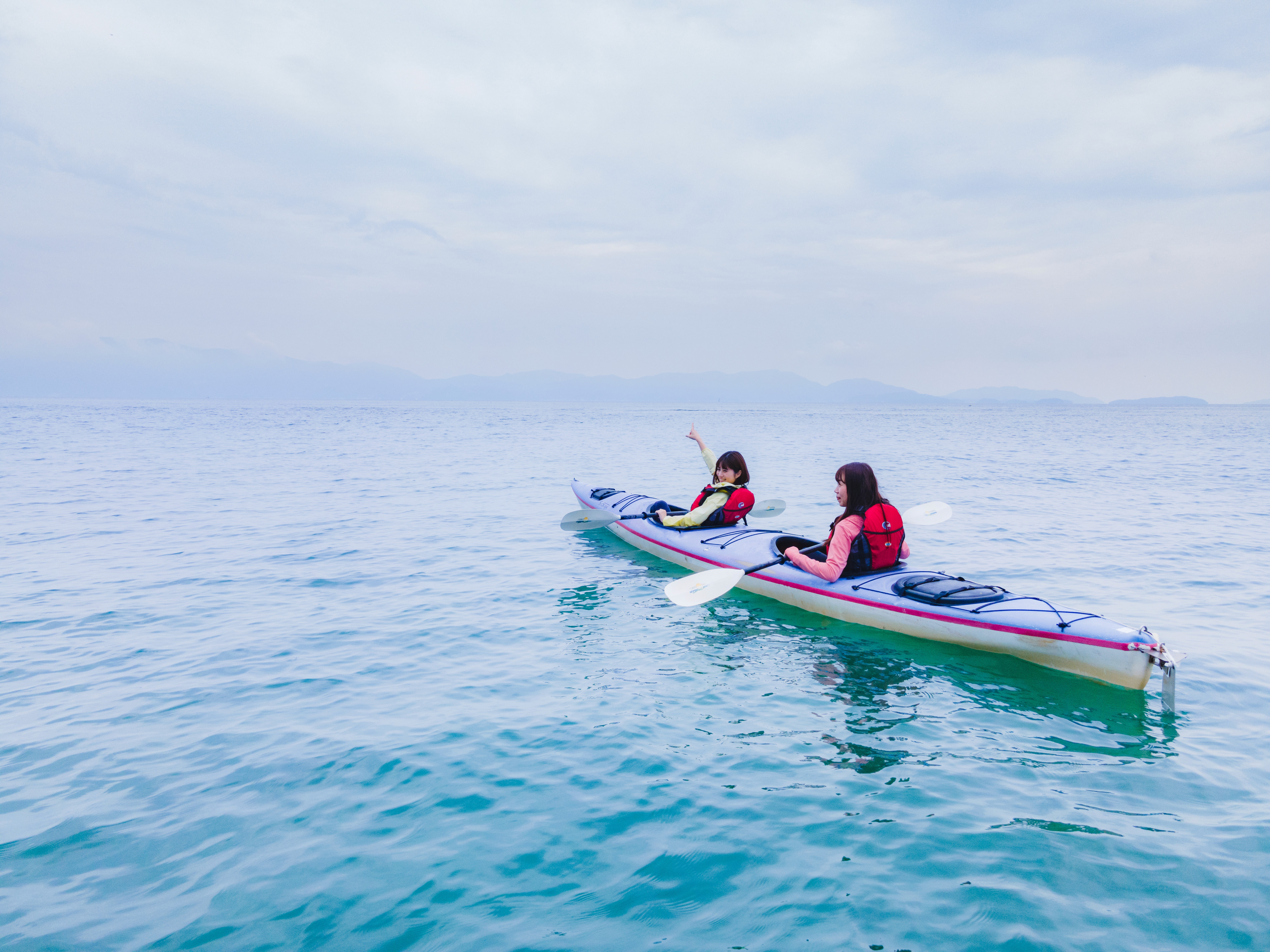 Two women kayaking on the crisp blue Seto Inland Sea 