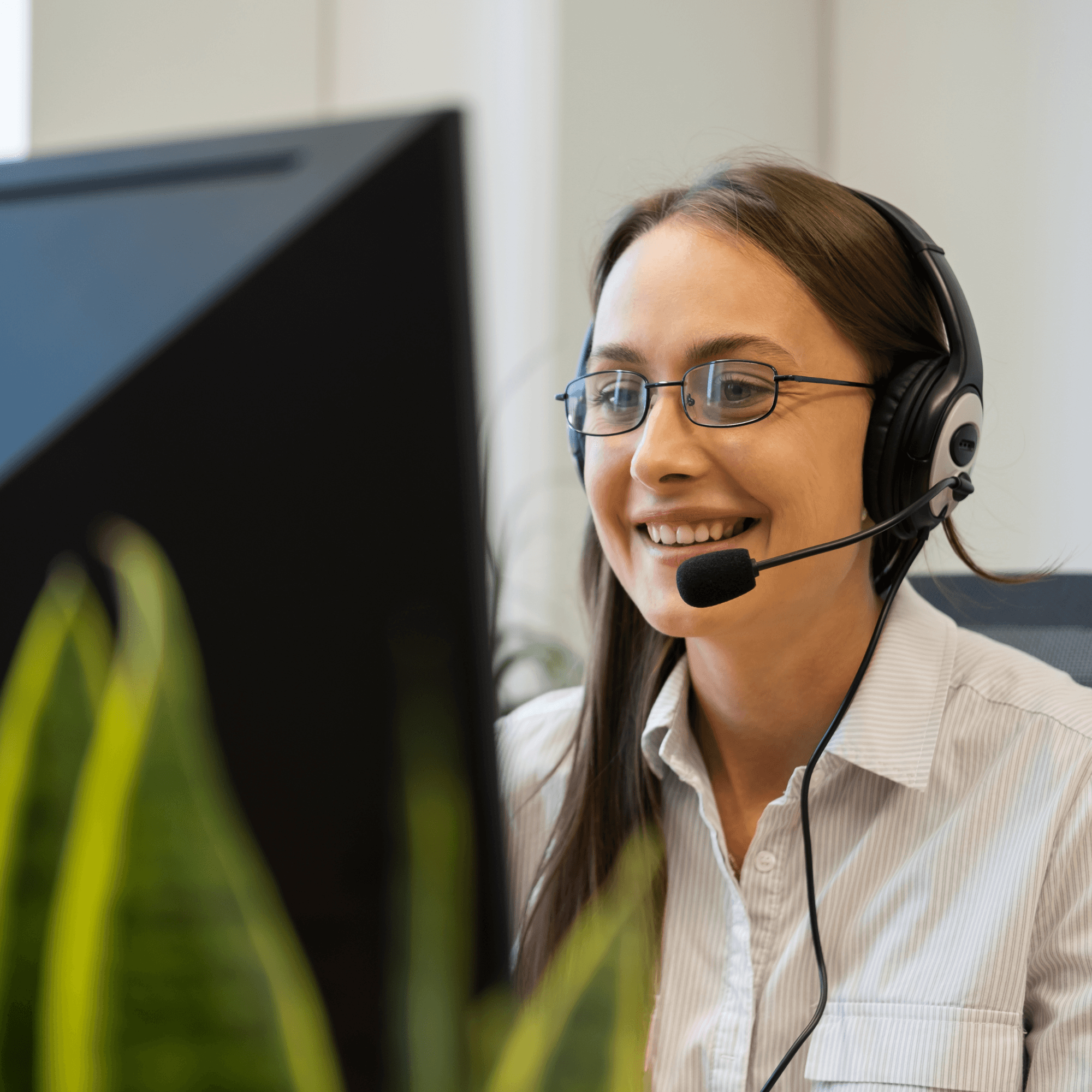 Smiling Irish Life Health advisor wearing a headset while assisting a customer with their health insurance enquiry.