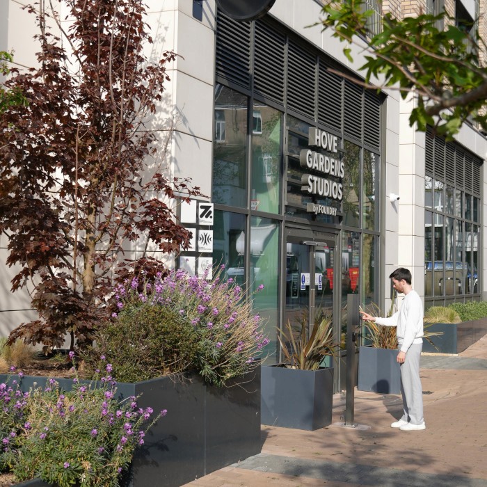 Modern office entrance with man outside pressing doorbell