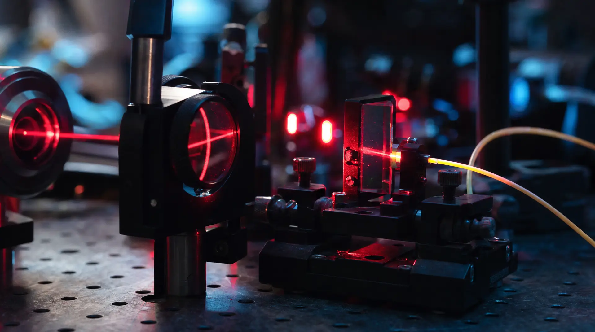Precision manufacturing tools for semiconductor marketing, with a robotic fixture and red laser glow in a high-tech lab.
