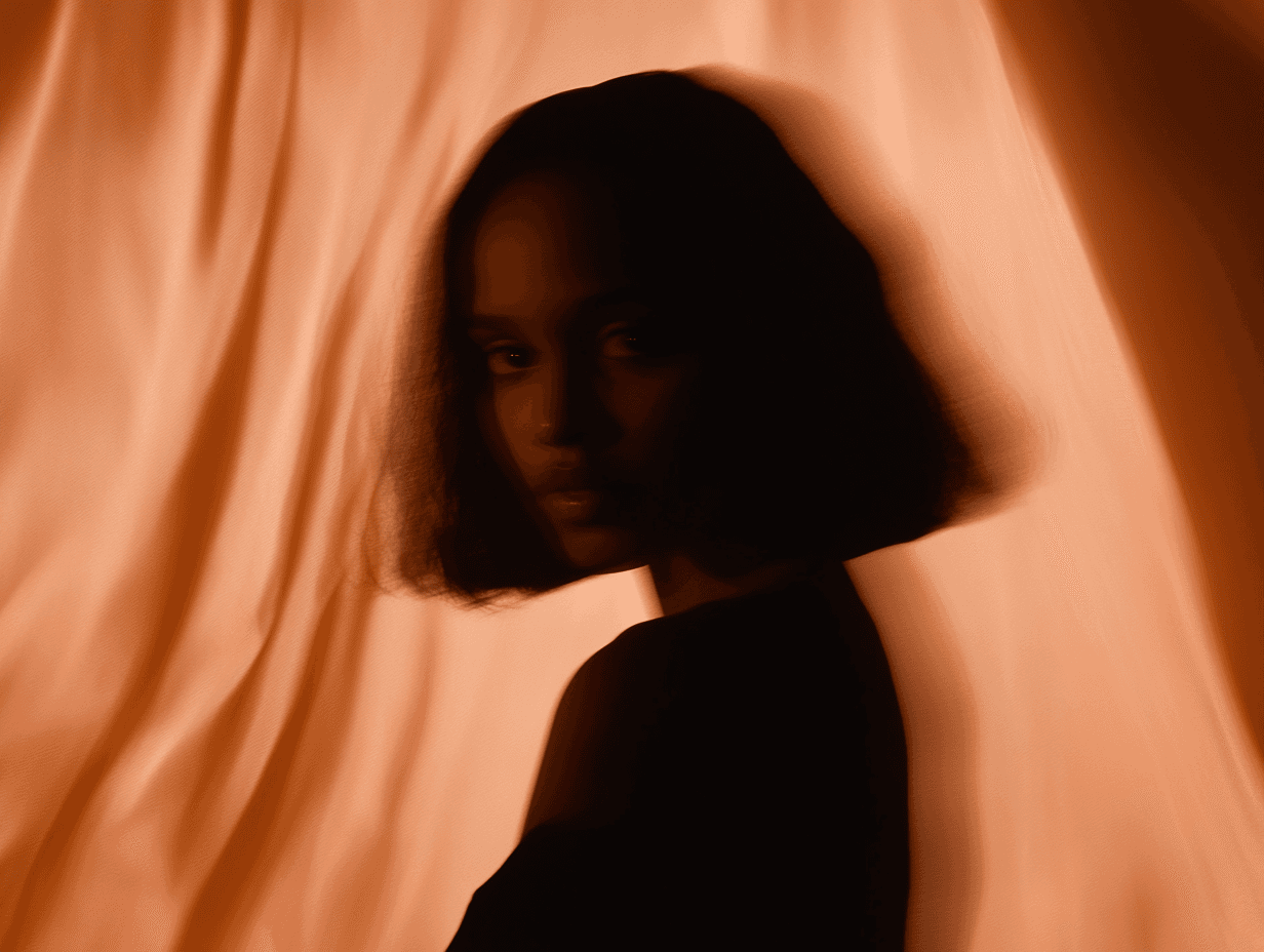 Portrait shot of a woman against a dark brown silk background