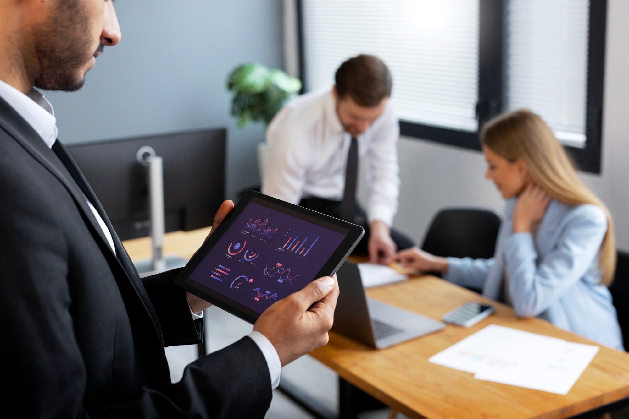 Team reviewing AI analytics and business intelligence dashboards in a modern office meeting.
