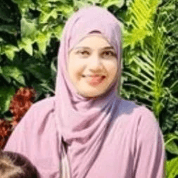 Close-up of a dark green leaf showing its textured surface and central vein against a muted background.