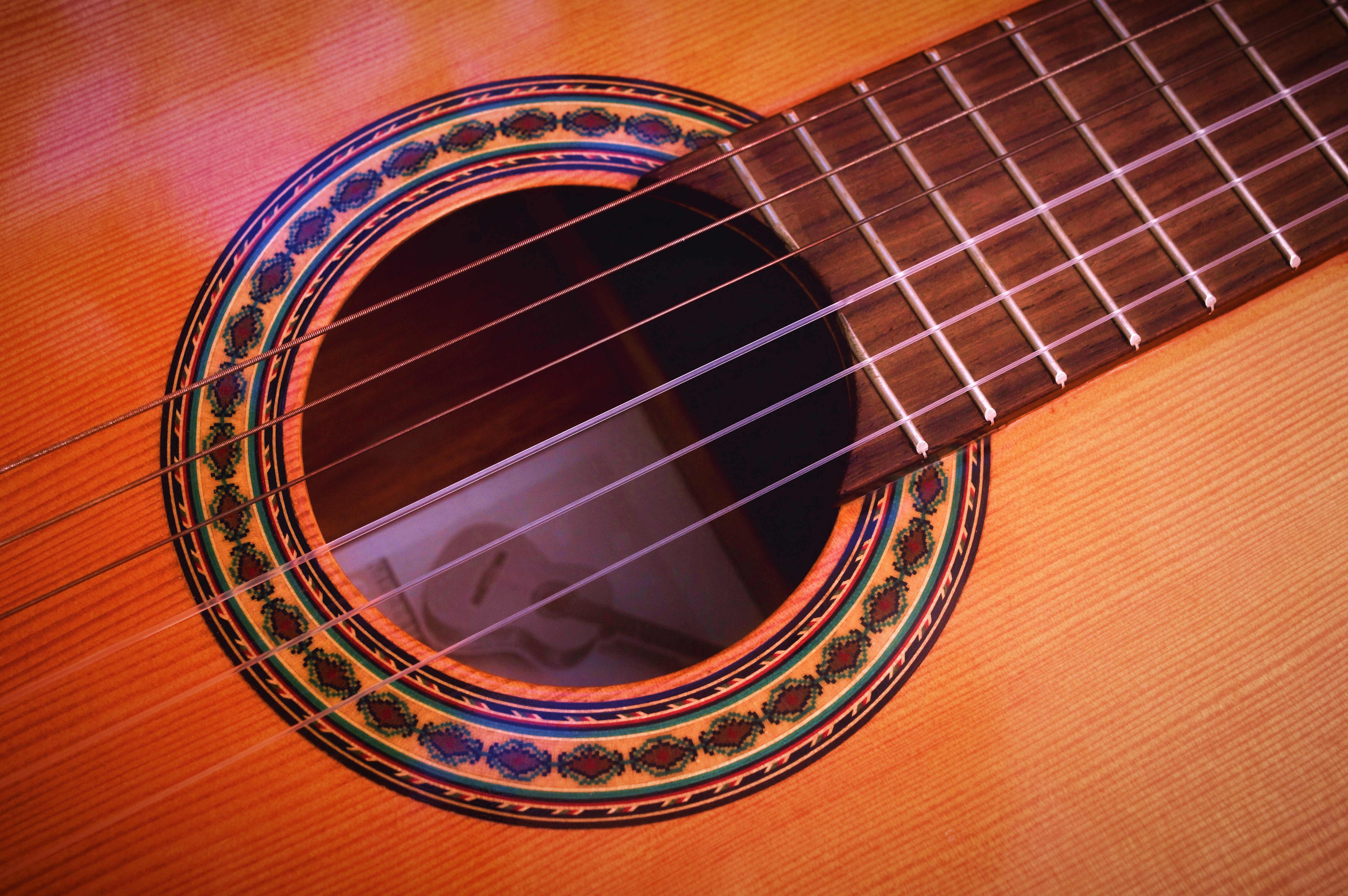 Close up of the sound port of an acoustic guitar
