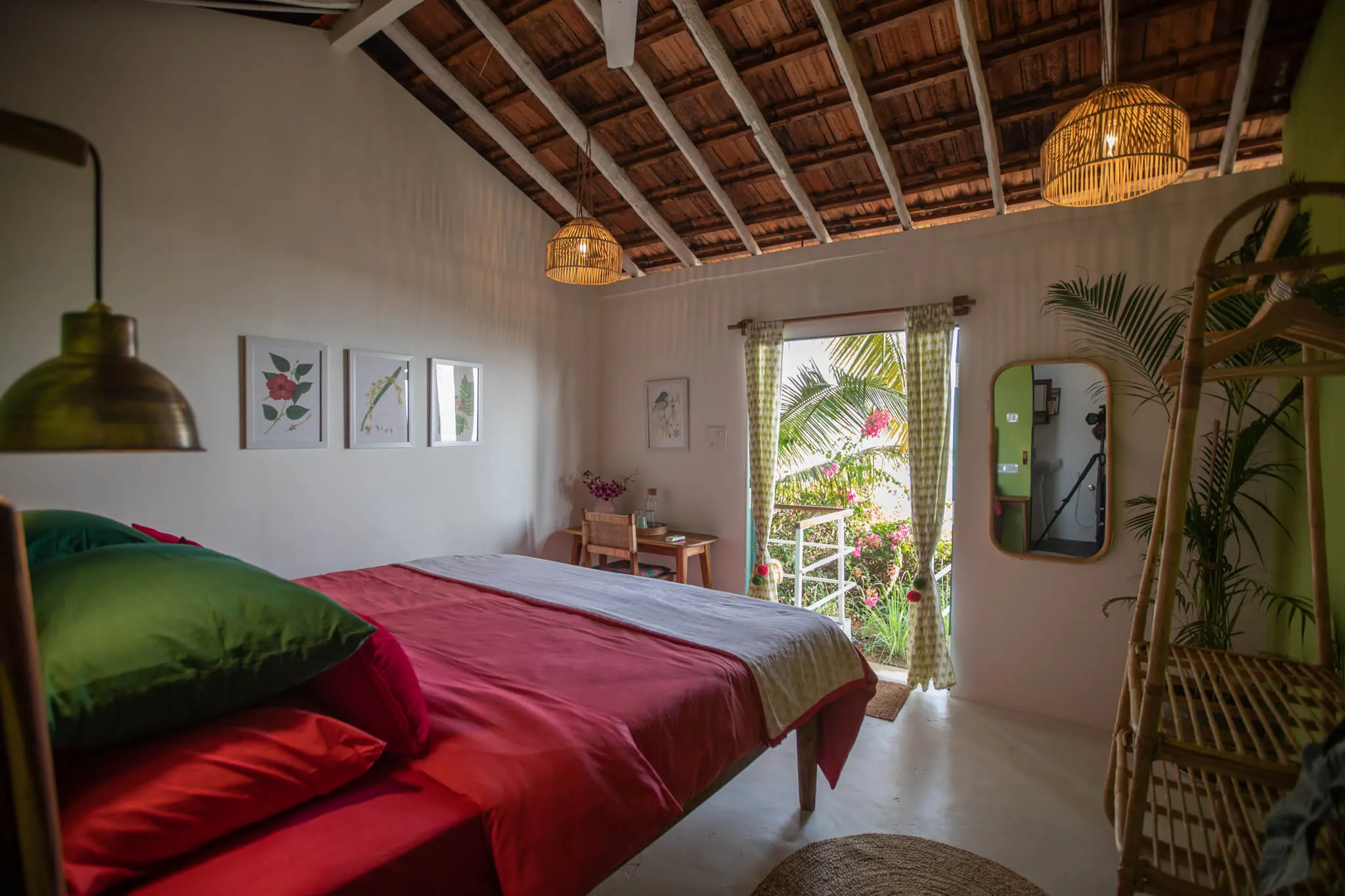 Light-filled bedroom with red linens at Casa Jaali
