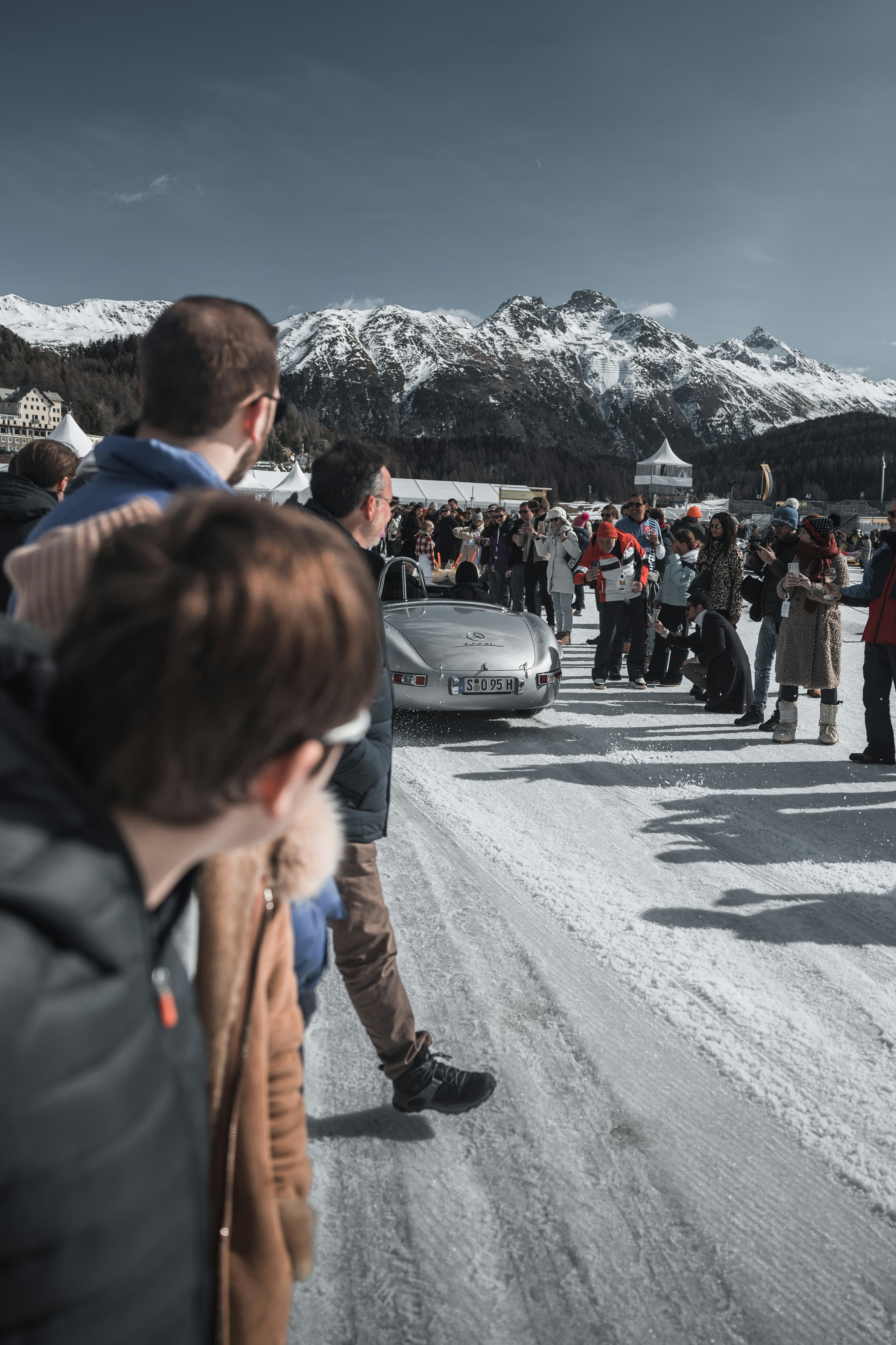 A group of people standing on a snow covered road