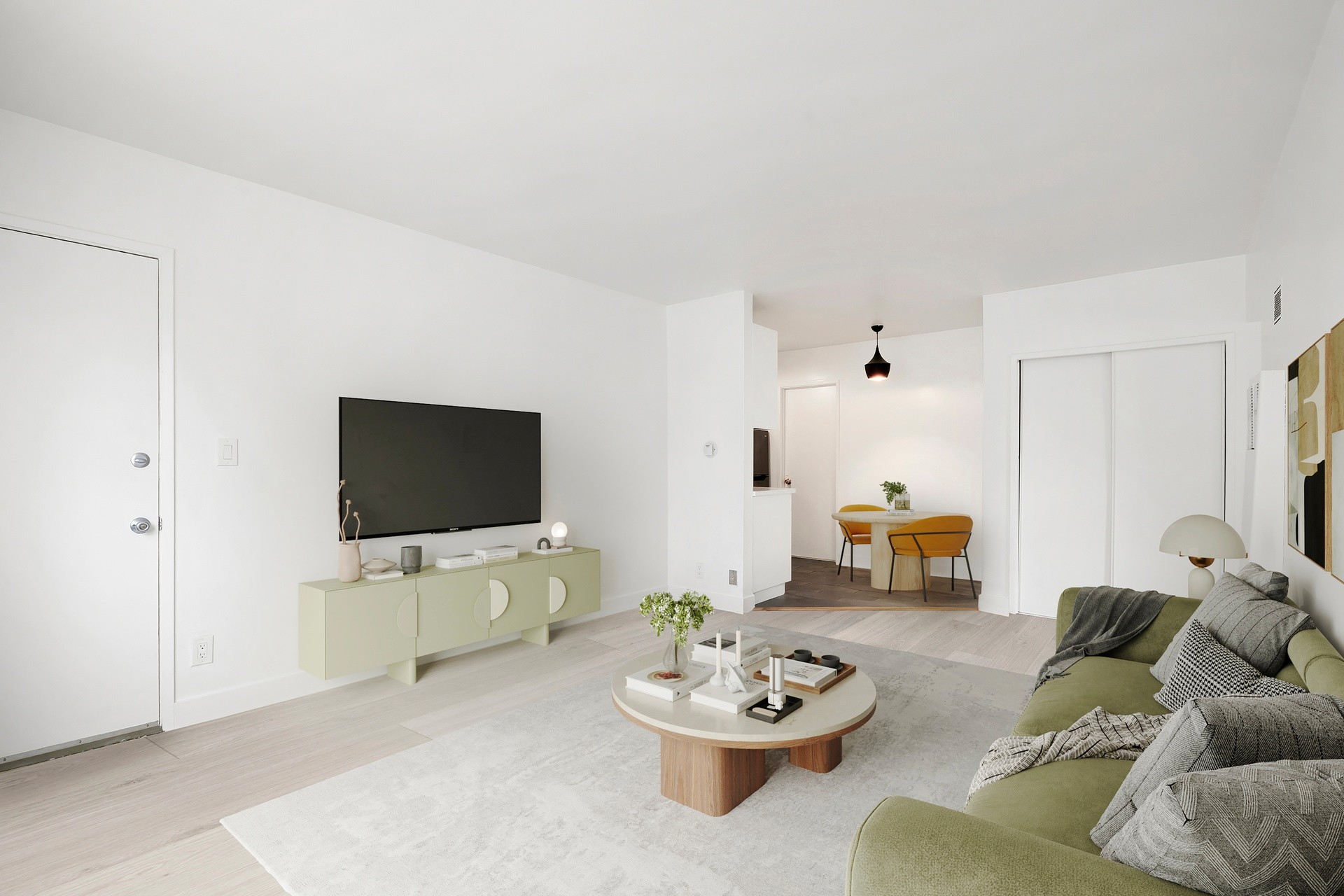 200 N Rampart staged living and dining area with modern furnishings, bright walls and open layout.