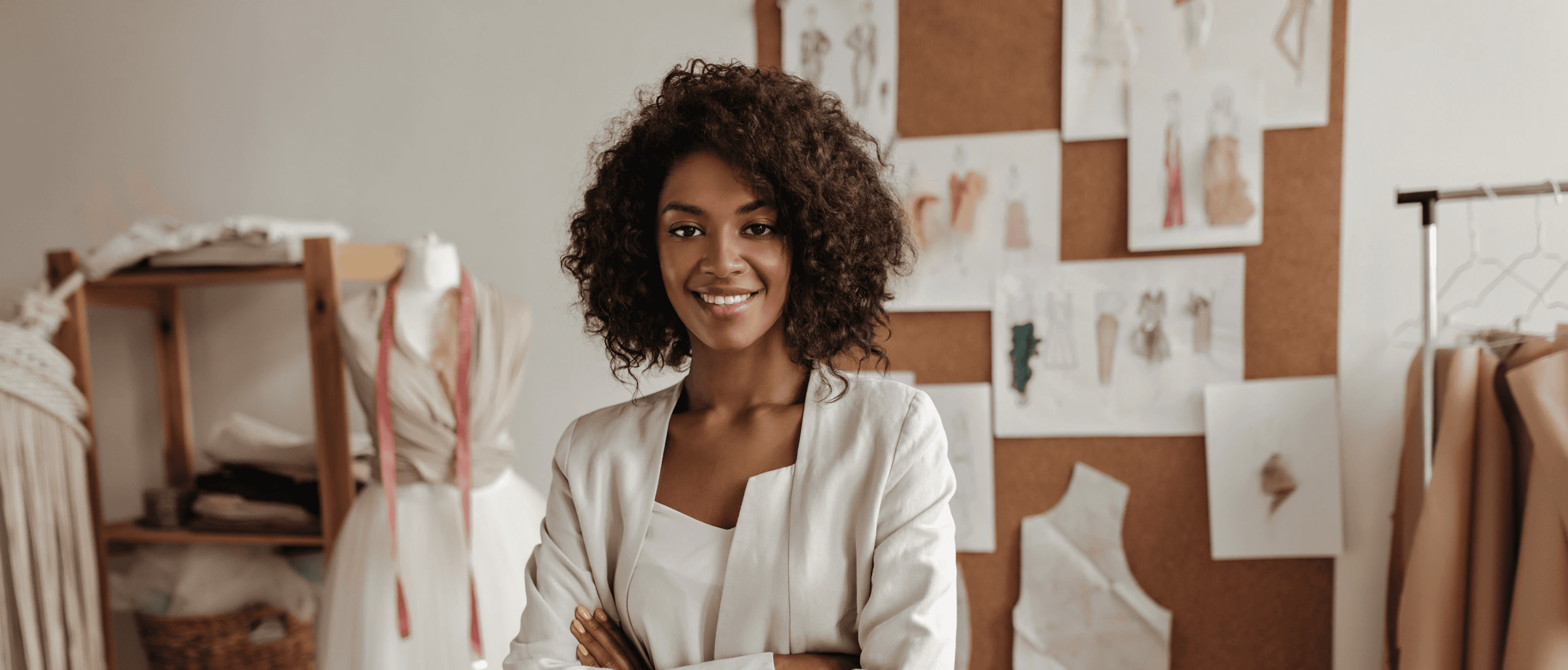 A female fashion designer standing up and folding her arms