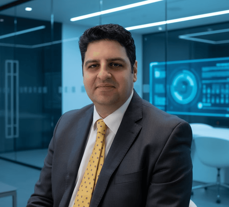 Portrait of a young man with short hair, wearing a dark t-shirt, against a plain background.
