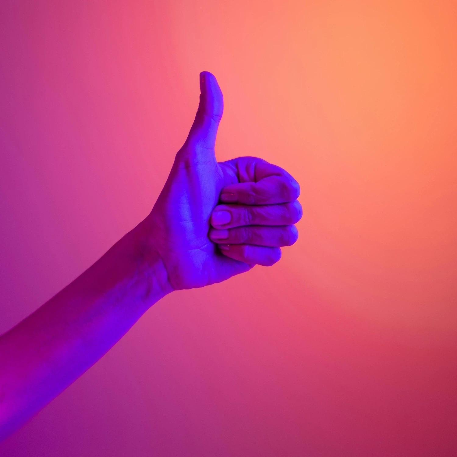 Brightly lit image of a hand giving a thumbs-up gesture, representing positive feedback and successful outcomes from LGBTQ couples counseling in Los Angeles.
