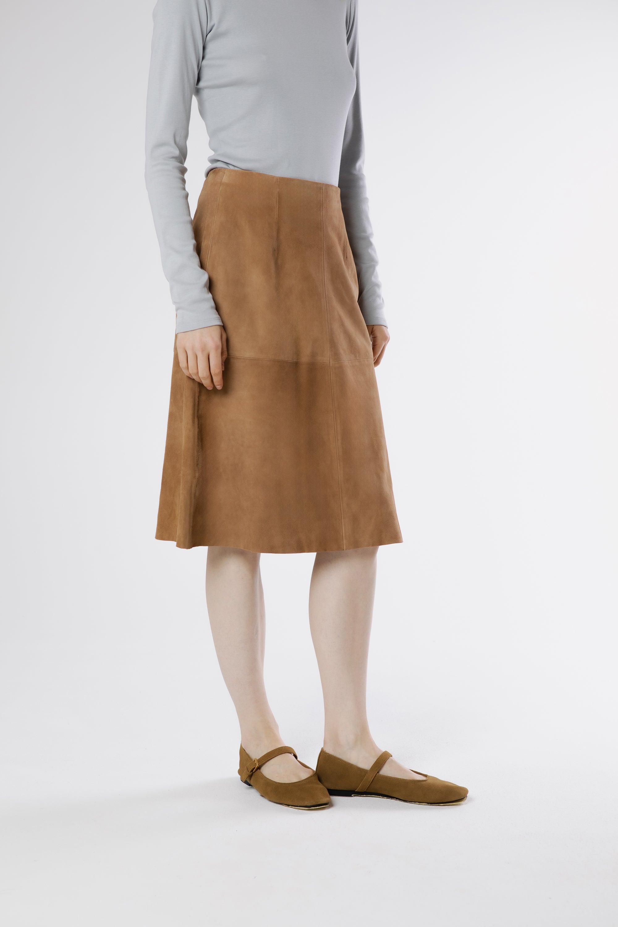 Side view of Otella midi skirt in oak suede highlighting gentle flare and natural movement