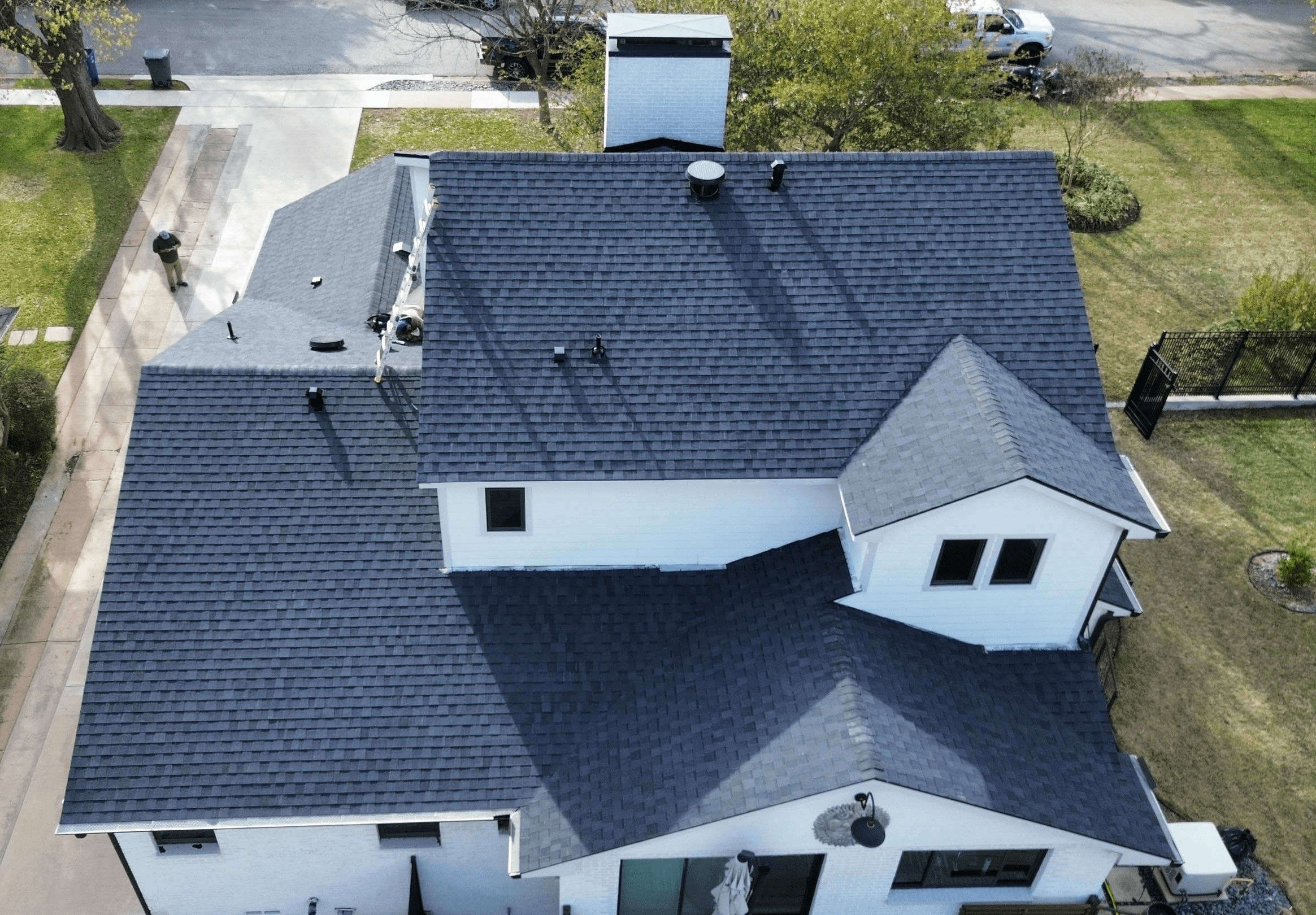 Drone aerial of the finished asphalt shingle roof installation on an Oak Cliff home in Dallas