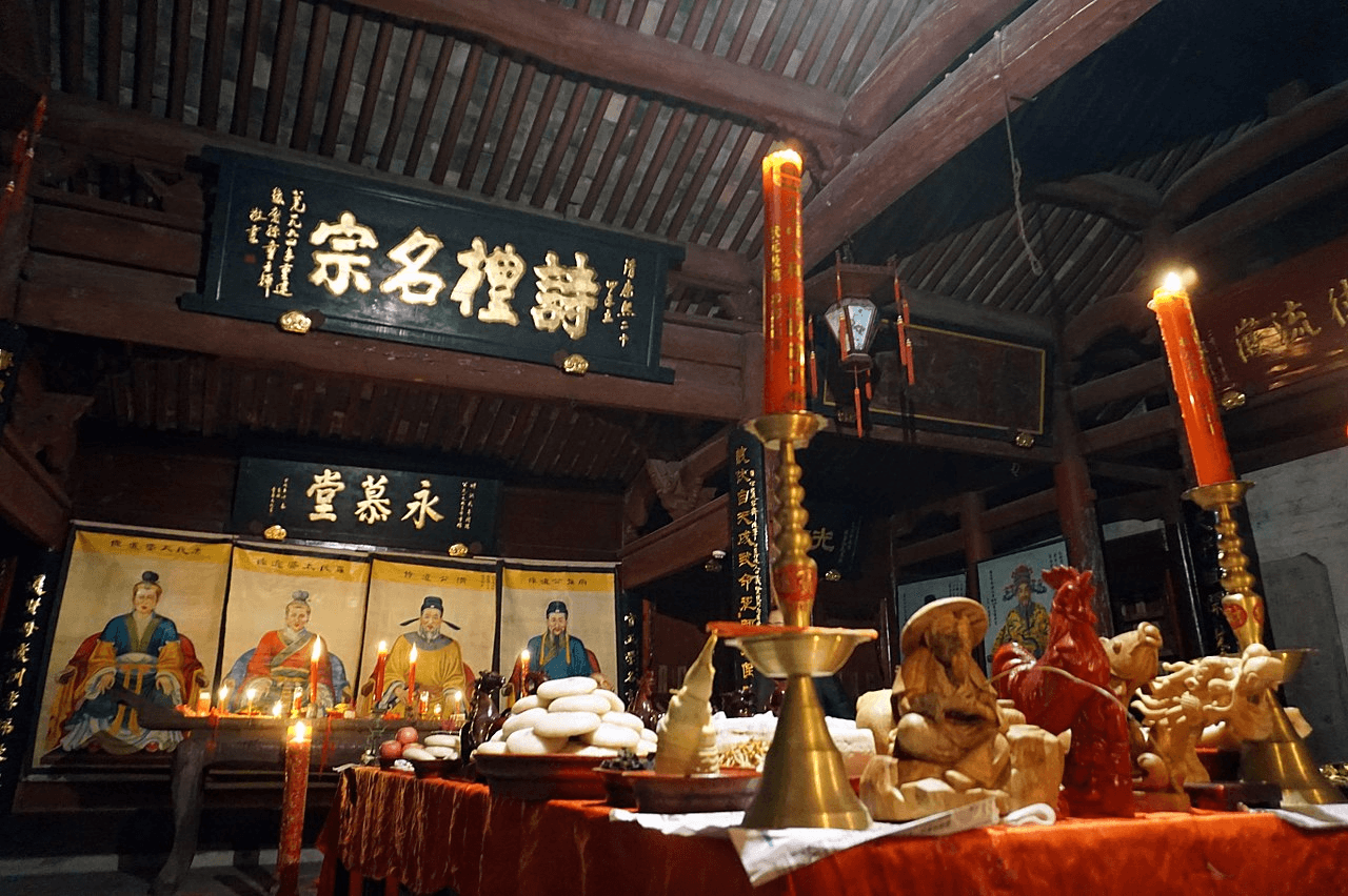 A place to worship ancestors with candles and portraits in China.