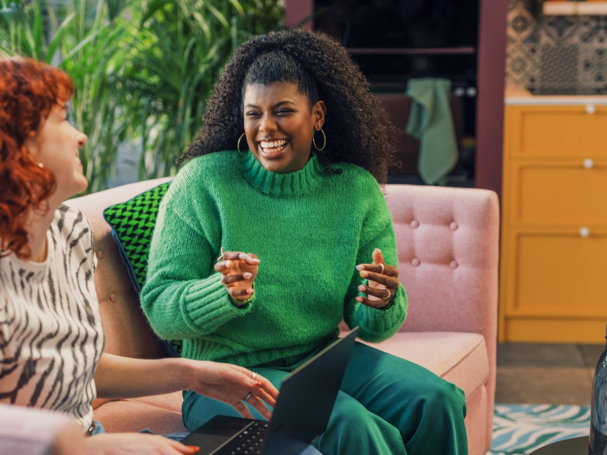 Image of two women laughing about how easy is to setup a bank account with GoDutch