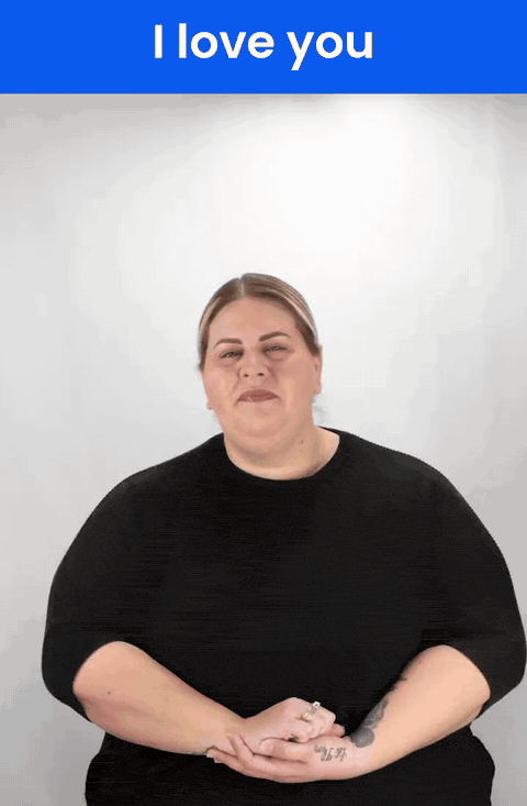 Animated GIF: a Deaf signer signs I LOVE YOU in ASL, thumb, index finger and pinky raised with the palm out.