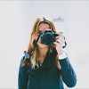 woman taking photo using DSLR camera