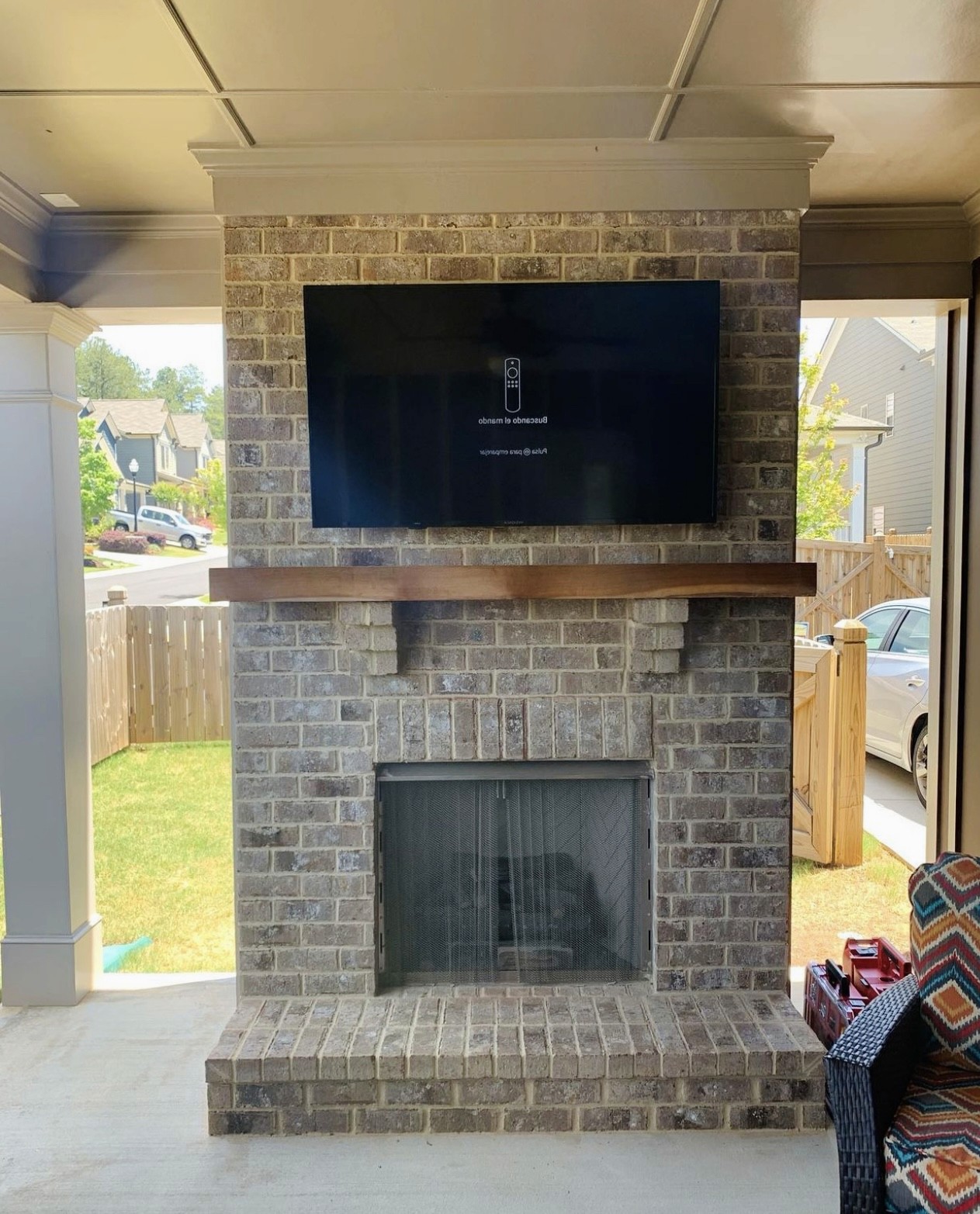 85-inch TV mounted using a over fireplace setup in a residential home in Tampa, with clean wiring and a modern look.