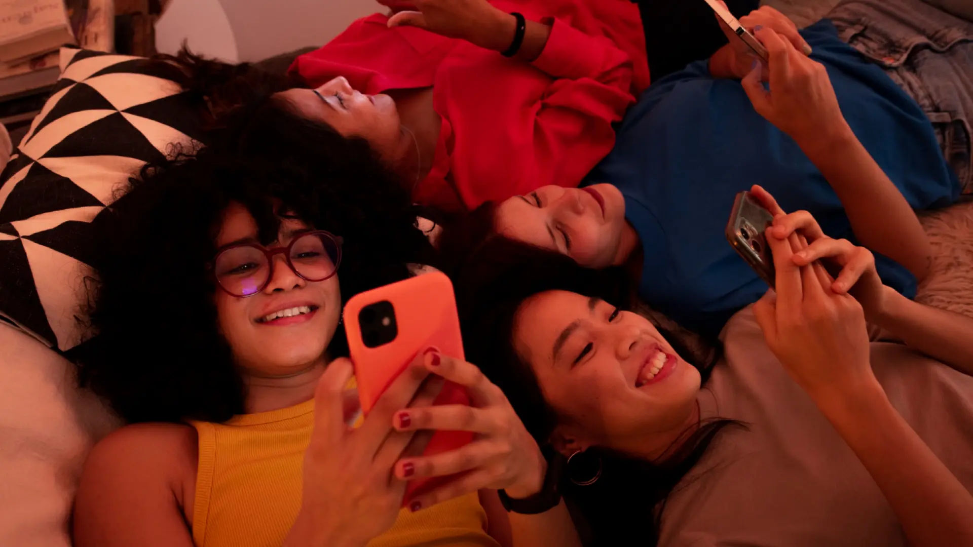 Friends hanging out and scrolling on their phones together, capturing a natural and unfiltered social media moment.