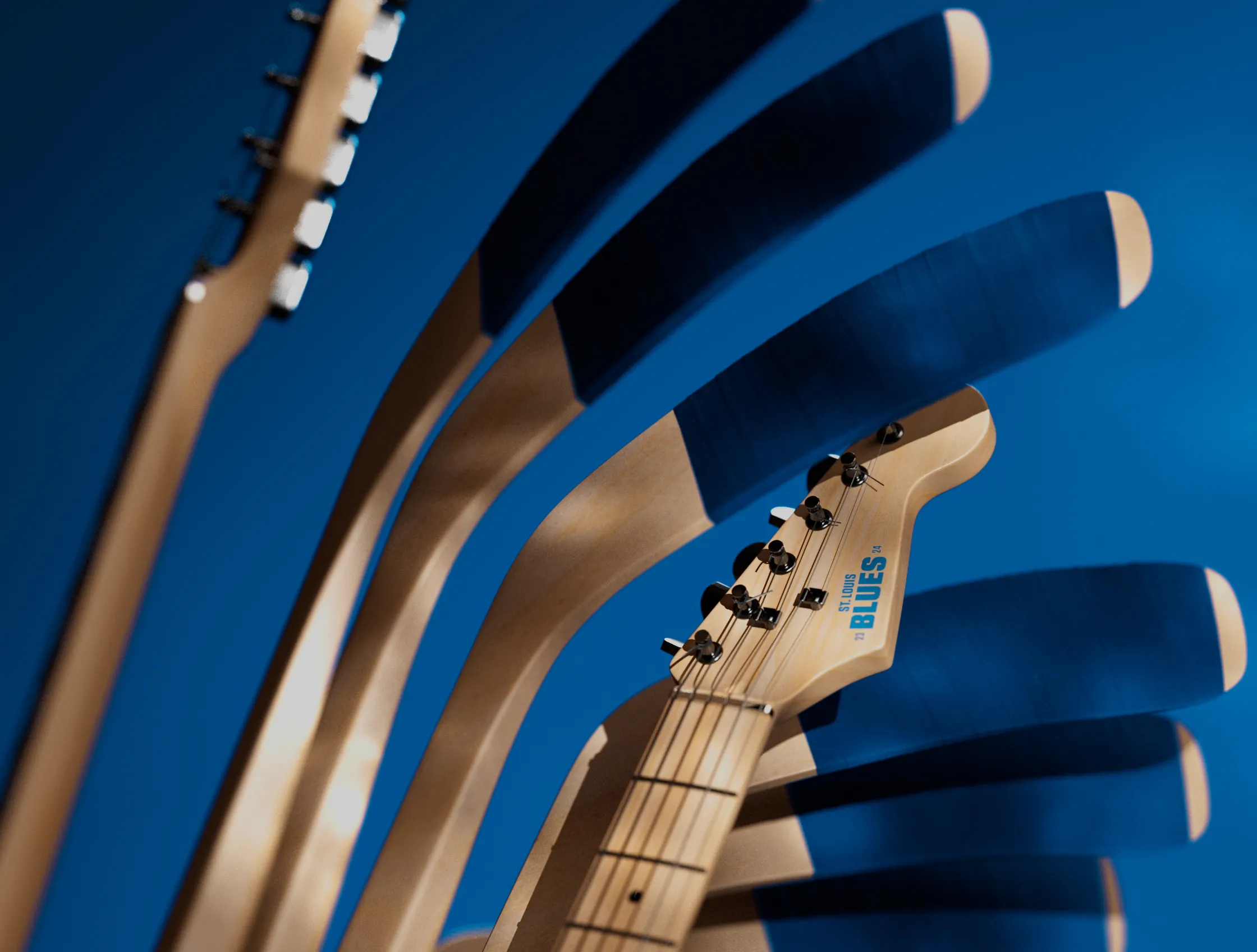 Close-up of St. Louis Blues electric guitar neck repeated in an abstract arc pattern on a blue background