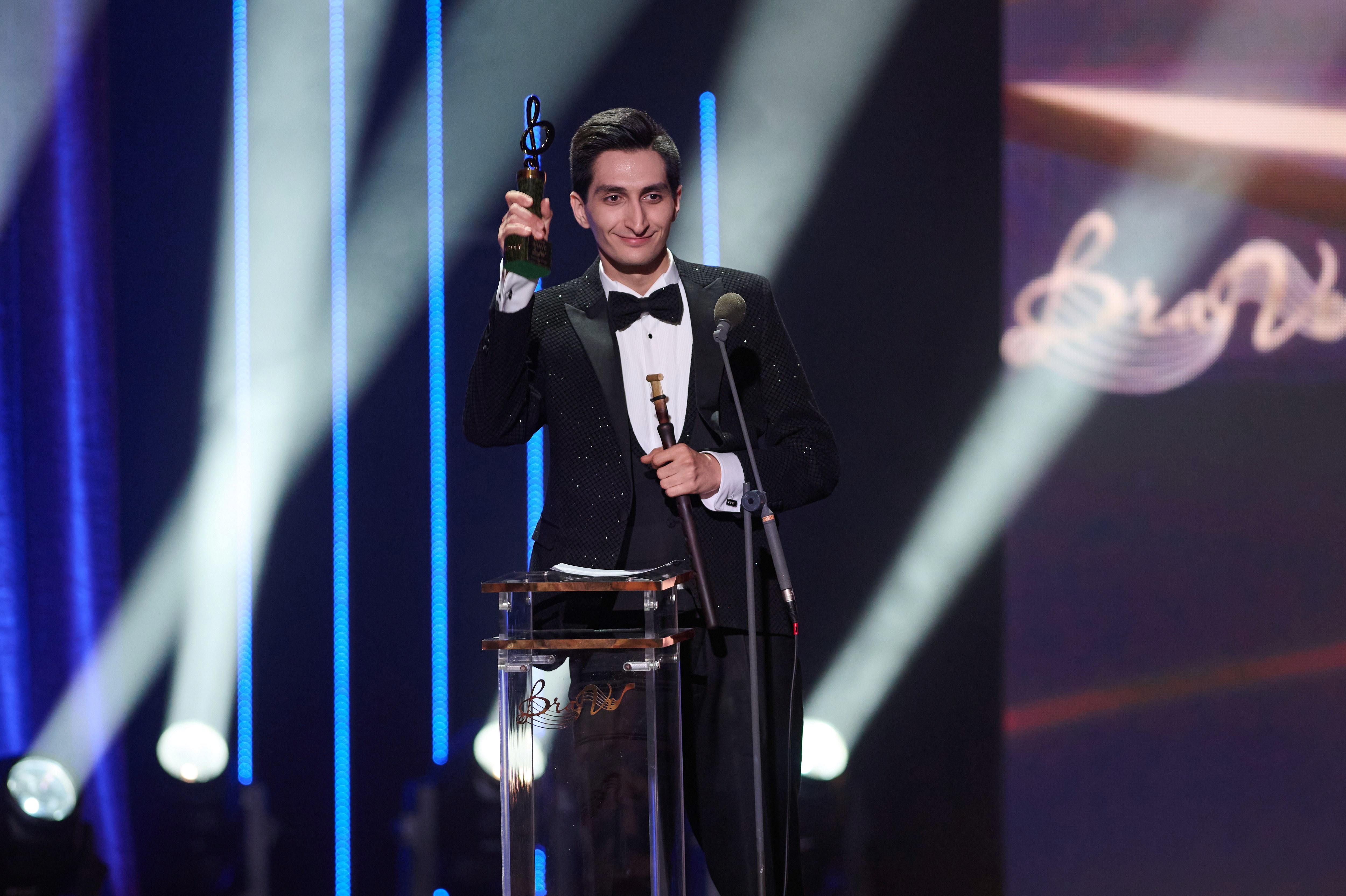     Erik Mirzoyan holding the BraVo Award on stage in 2026