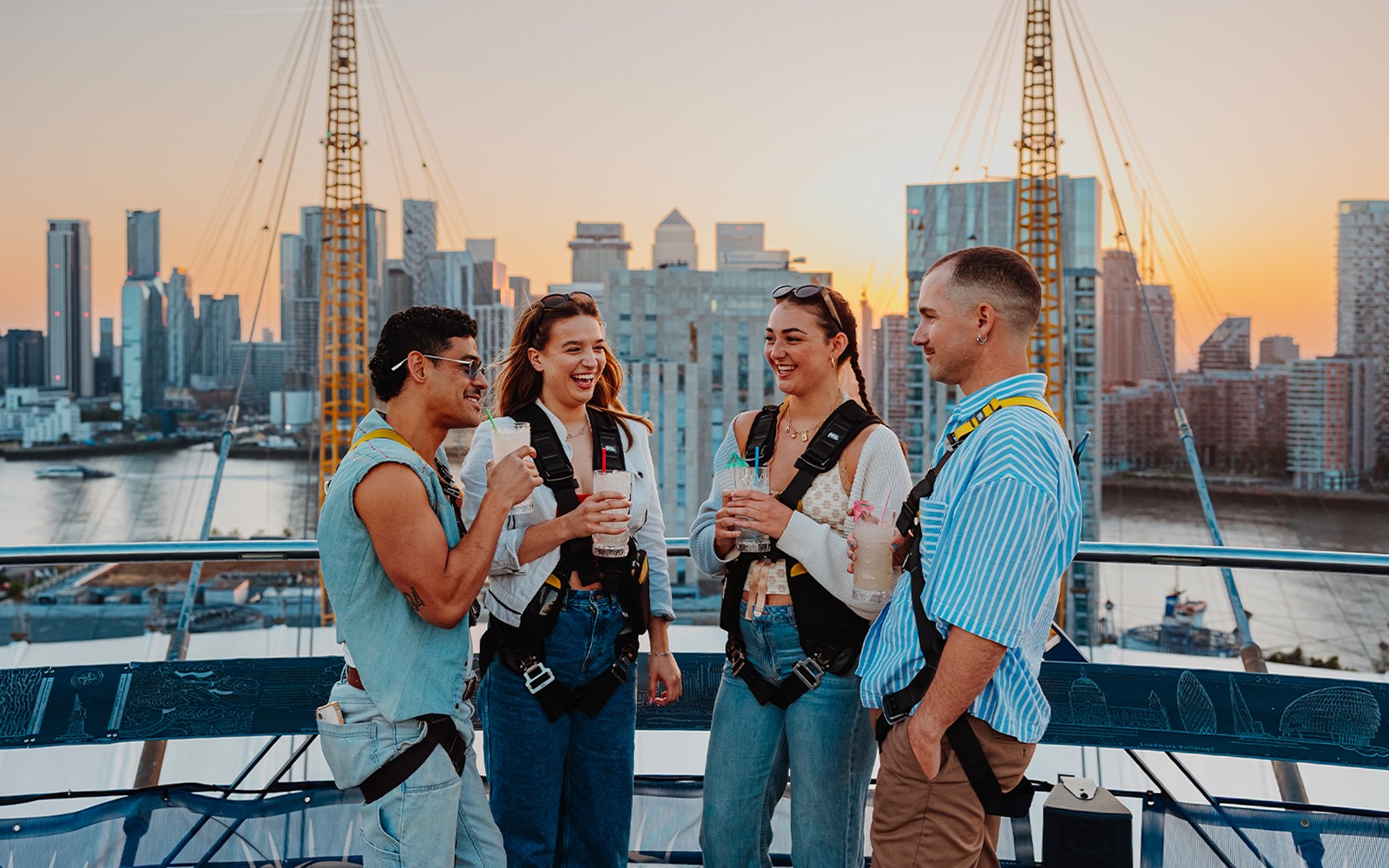 Guests enjoying drinks on the rooftop of The O2 in London with city skyline views.
