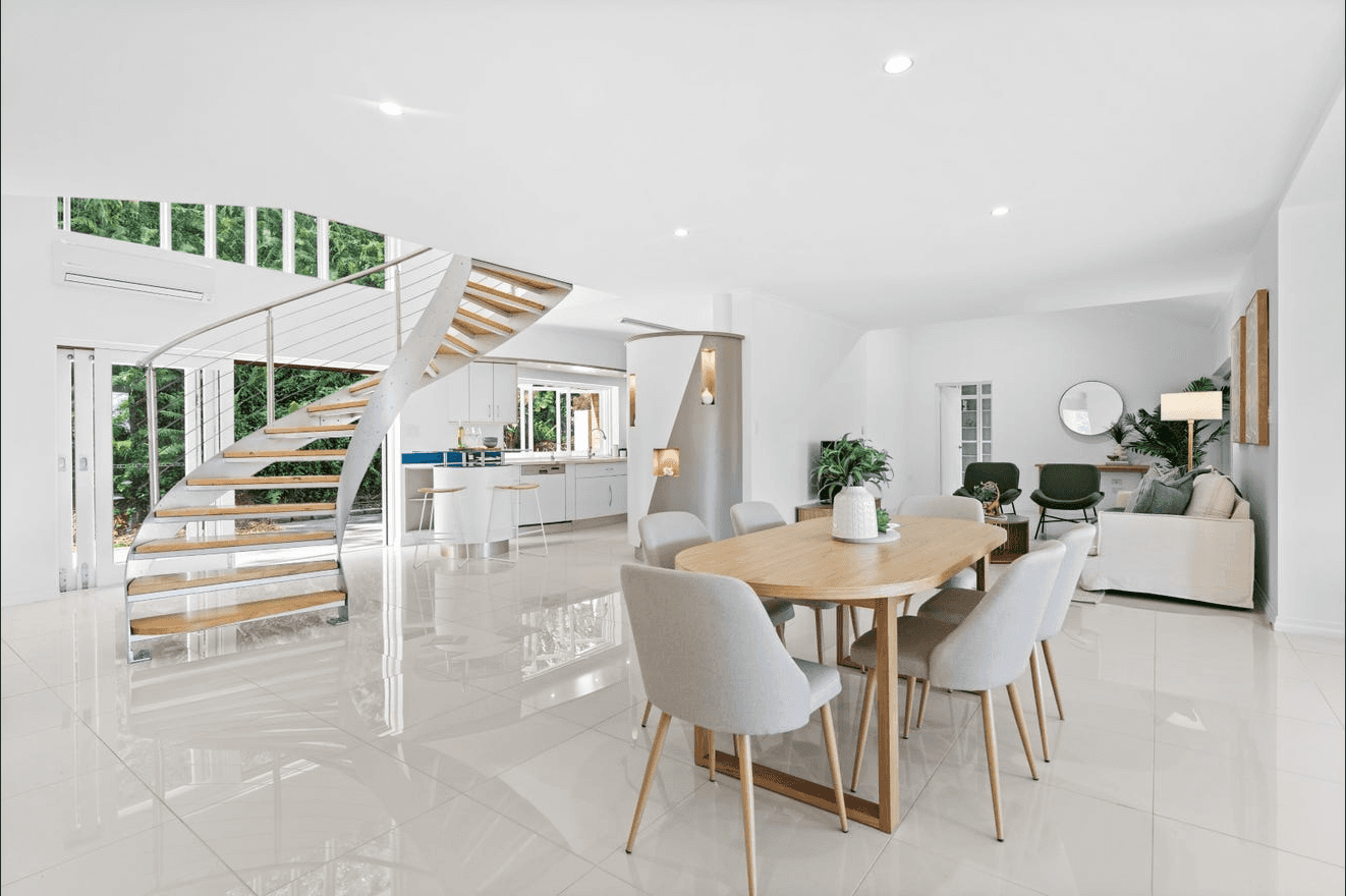 white steel chair in front round table on white rug