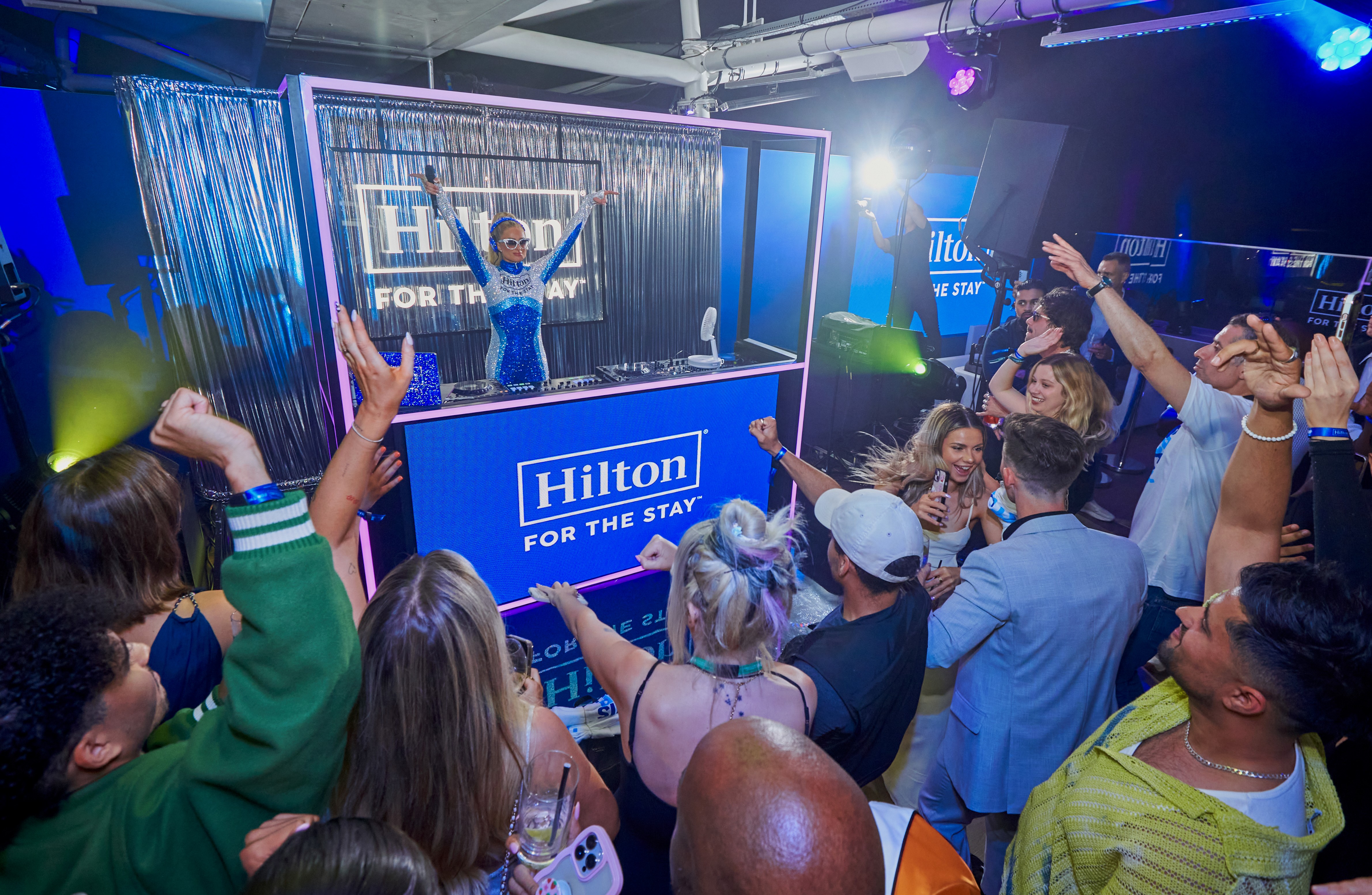 a woman sitting on a chair with a hair dryer