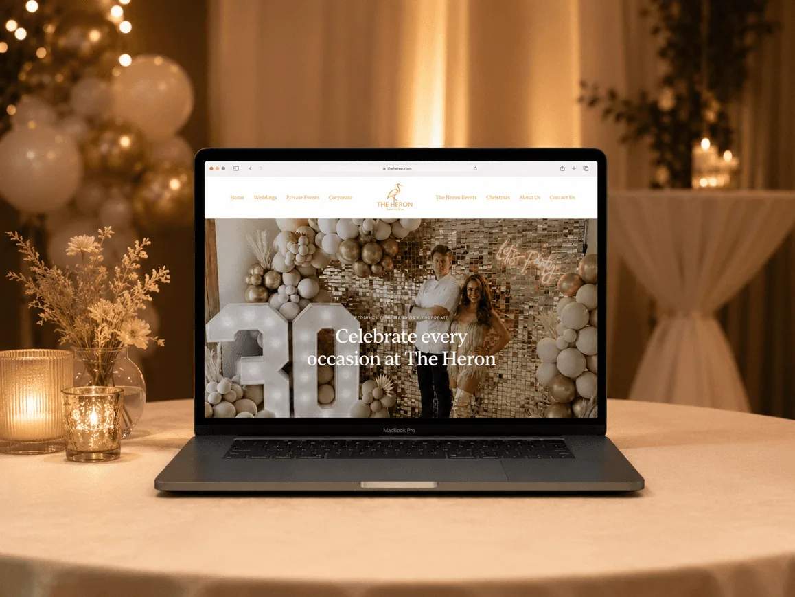 The Heron Country Club website displayed on a laptop
