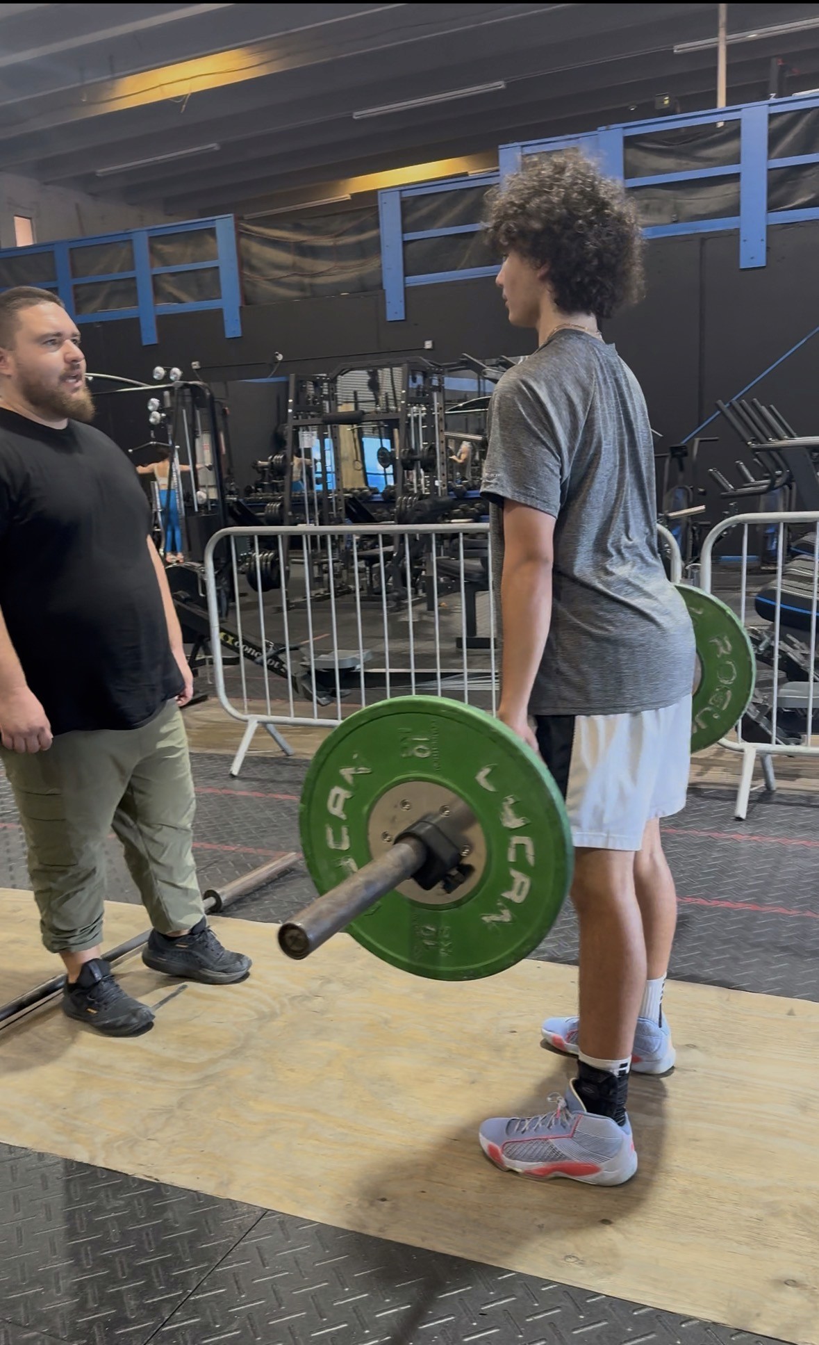 Overhead view of diverse athletes sprinting on a red running track, capturing speed, endurance, and competitive performance in sports and athletic training events.