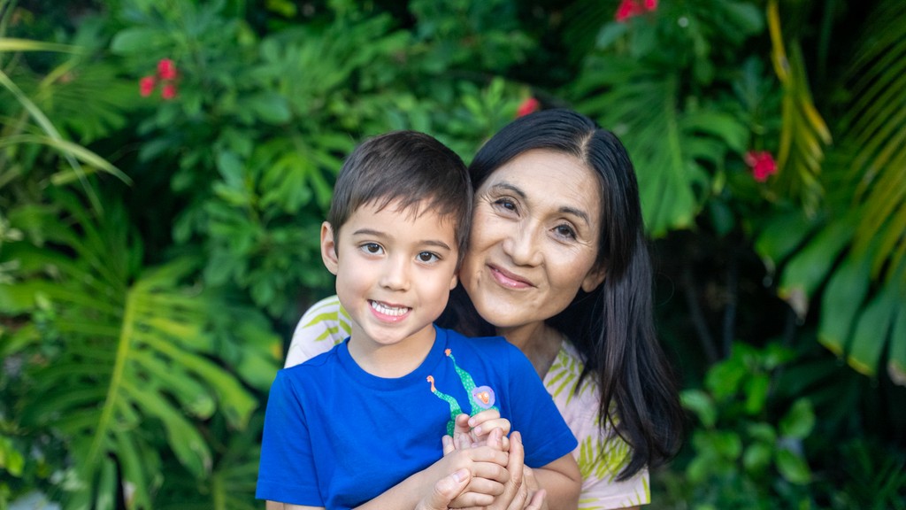 Grandma and Grandchild smile for picture in outdoor Hawai'i