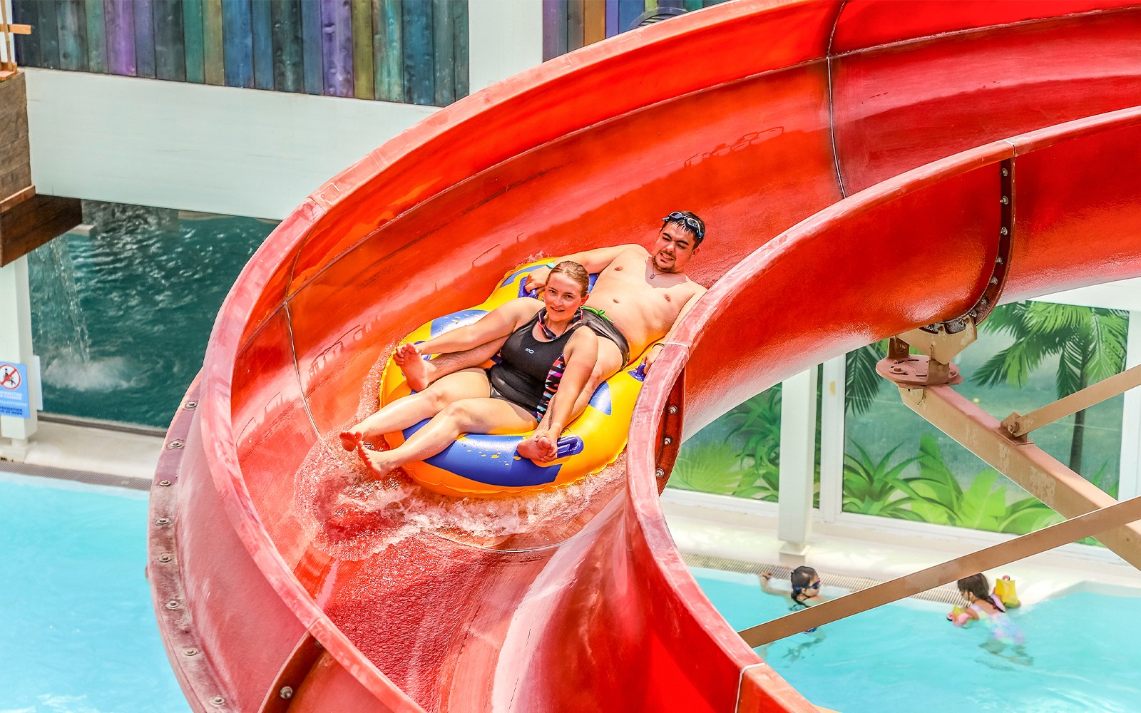 Tourists enjoying a water slide at Aqualibi Park, Belgium.
