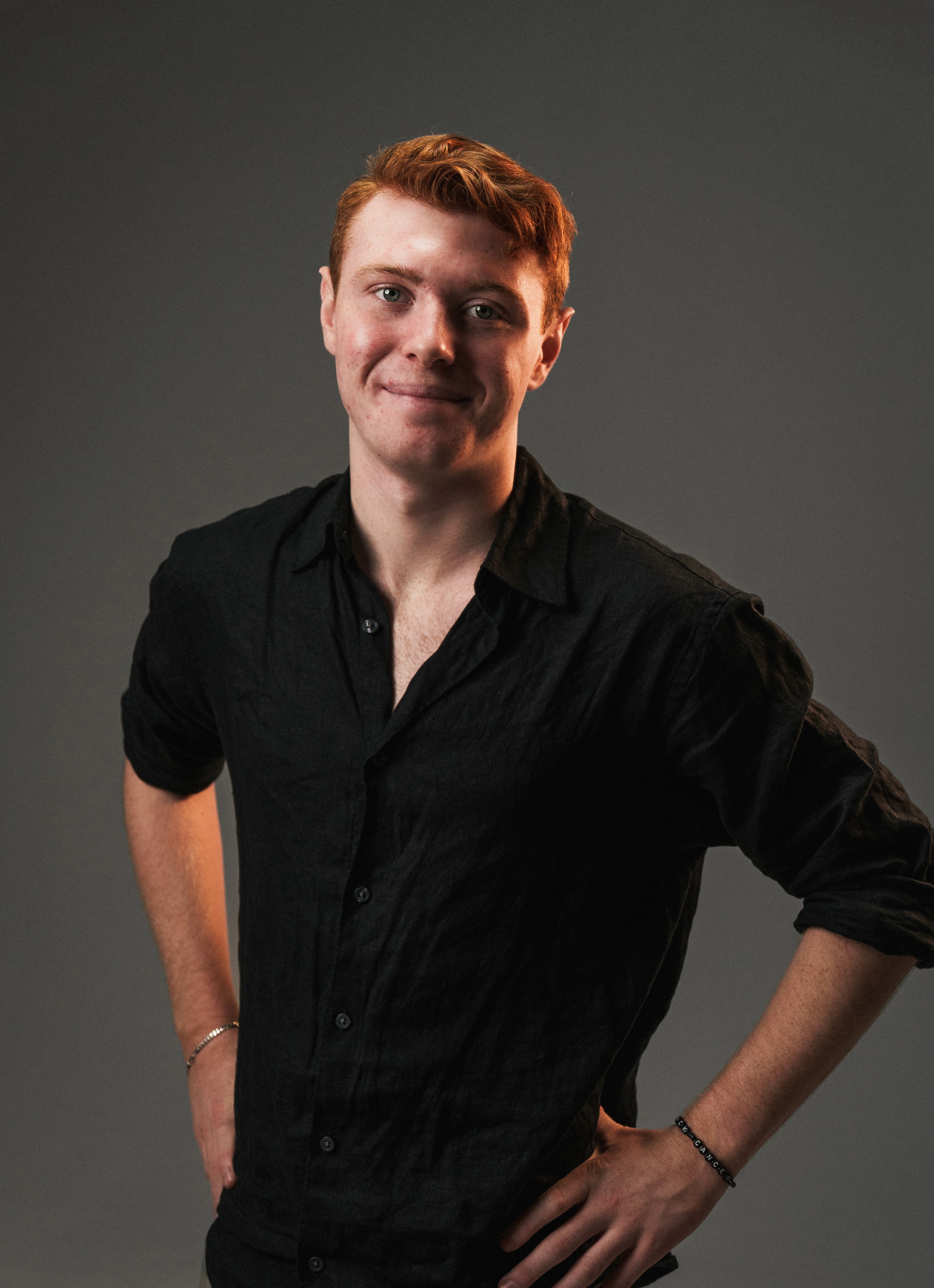 Portrait of a person in dark clothing speaking on a phone